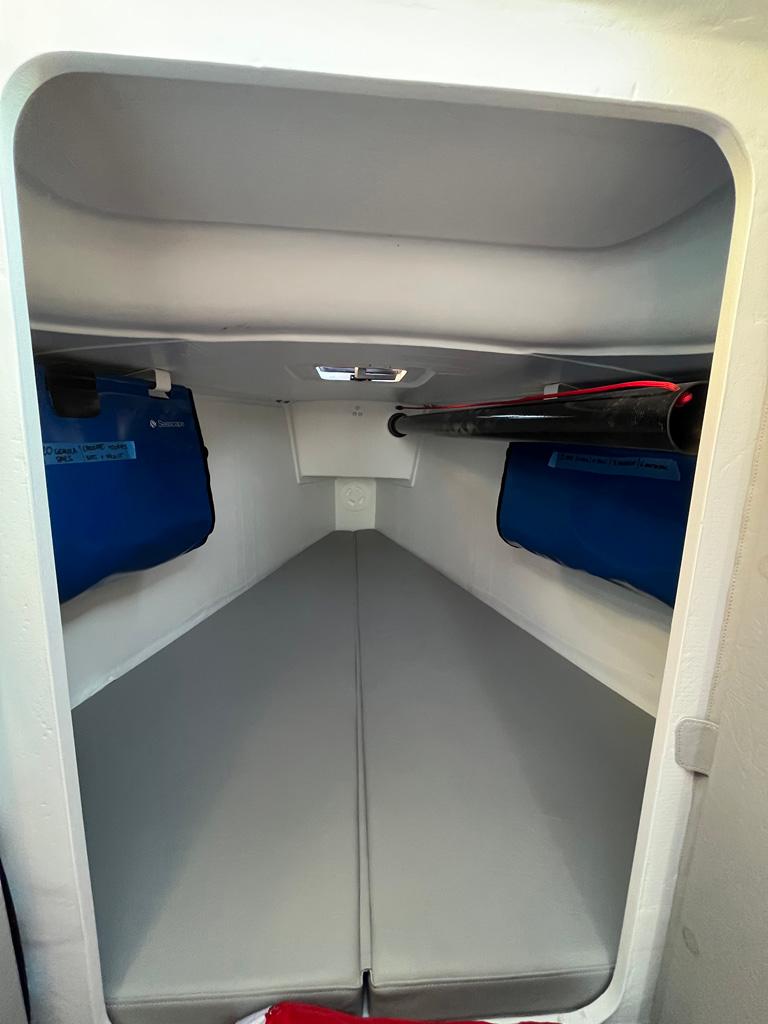 Interior cabin of a 2018 Seascape 27 sailboat, featuring blue storage pockets.