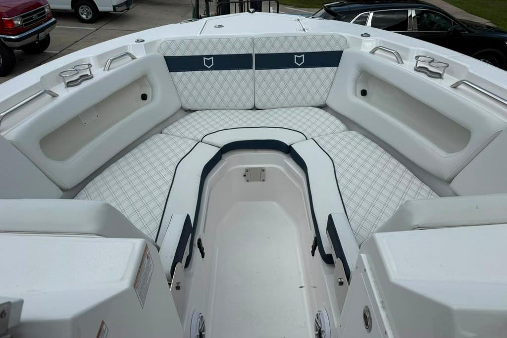 2026 Sea Fox 288 Traveler boat interior with white cushioned seating and storage compartments.