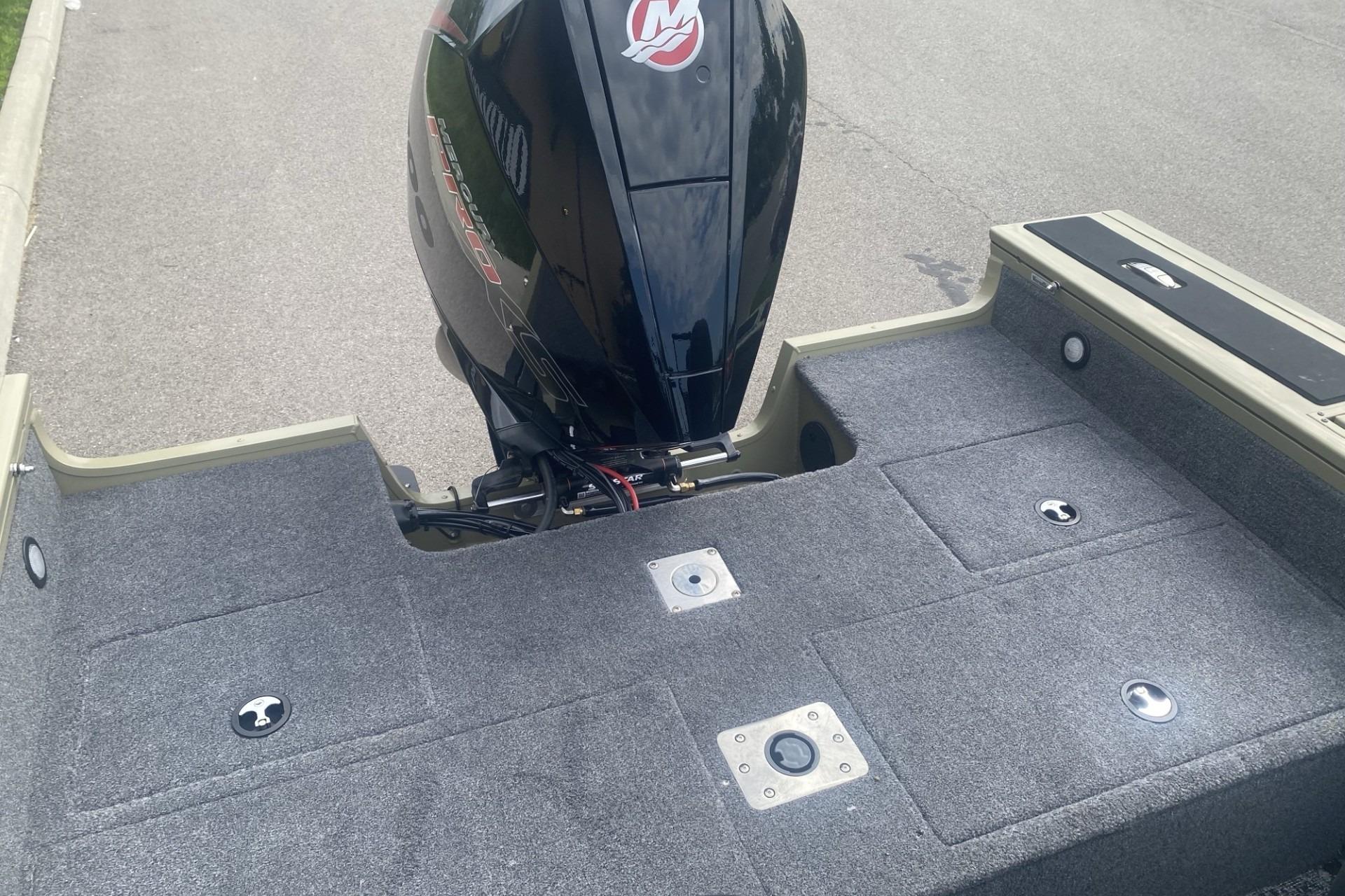 2026 Tracker Targa V-19 WT boat with powerful outboard motor on carpeted deck.