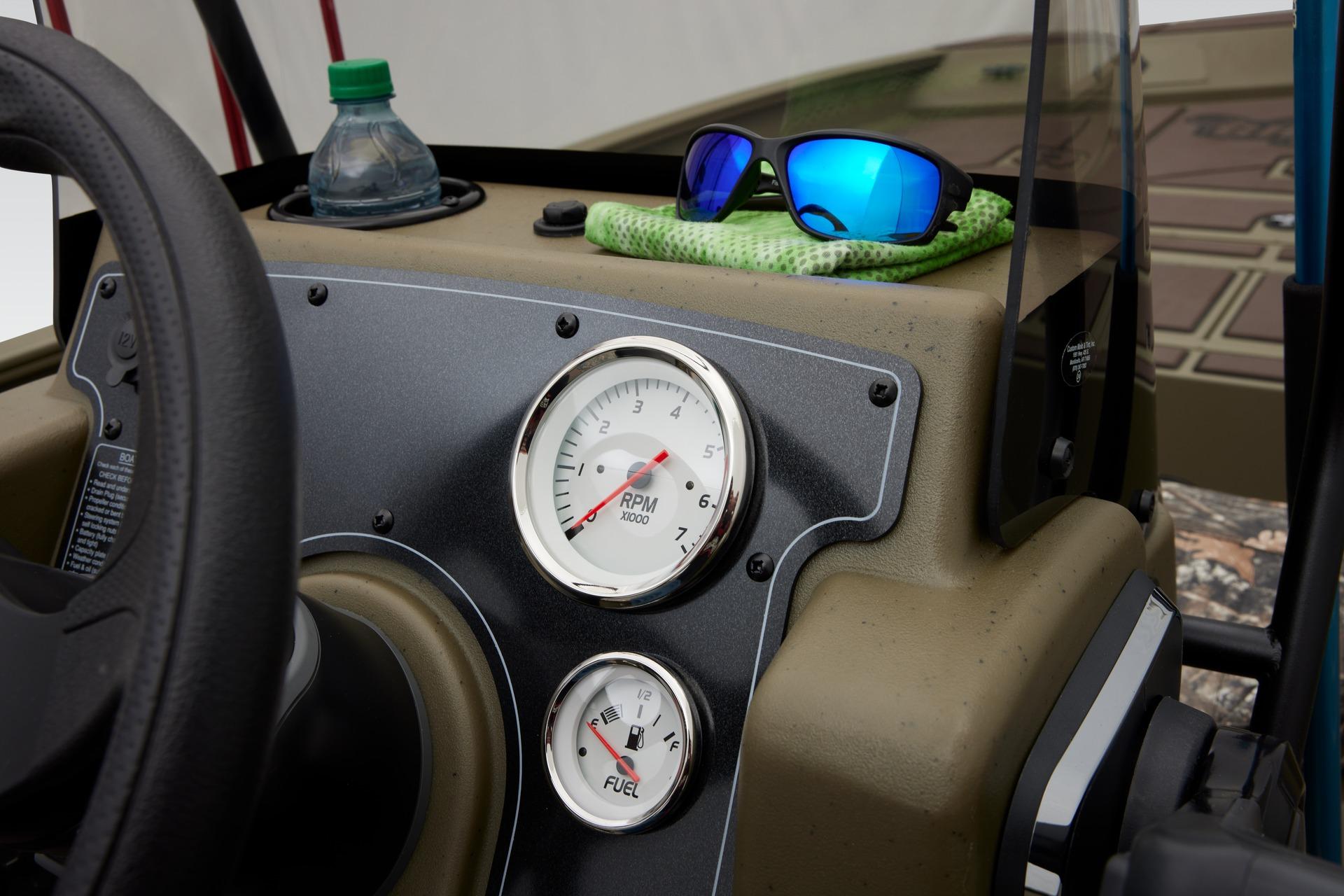 2024 Tracker Grizzly 2072 CC dashboard with gauges, sunglasses, and water bottle.