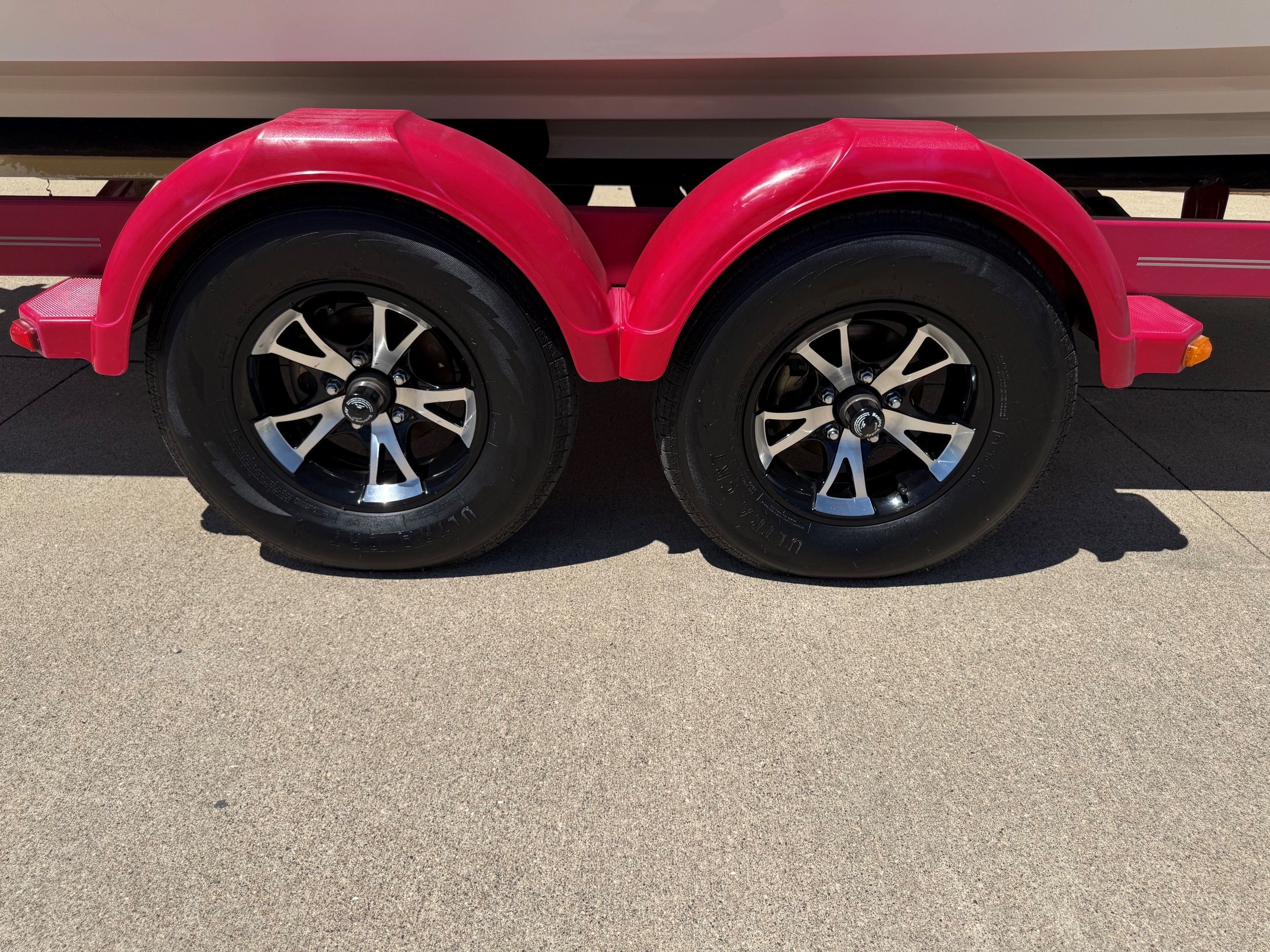 Red trailer wheels of a 2007 Sea Ray 230 Select boat.