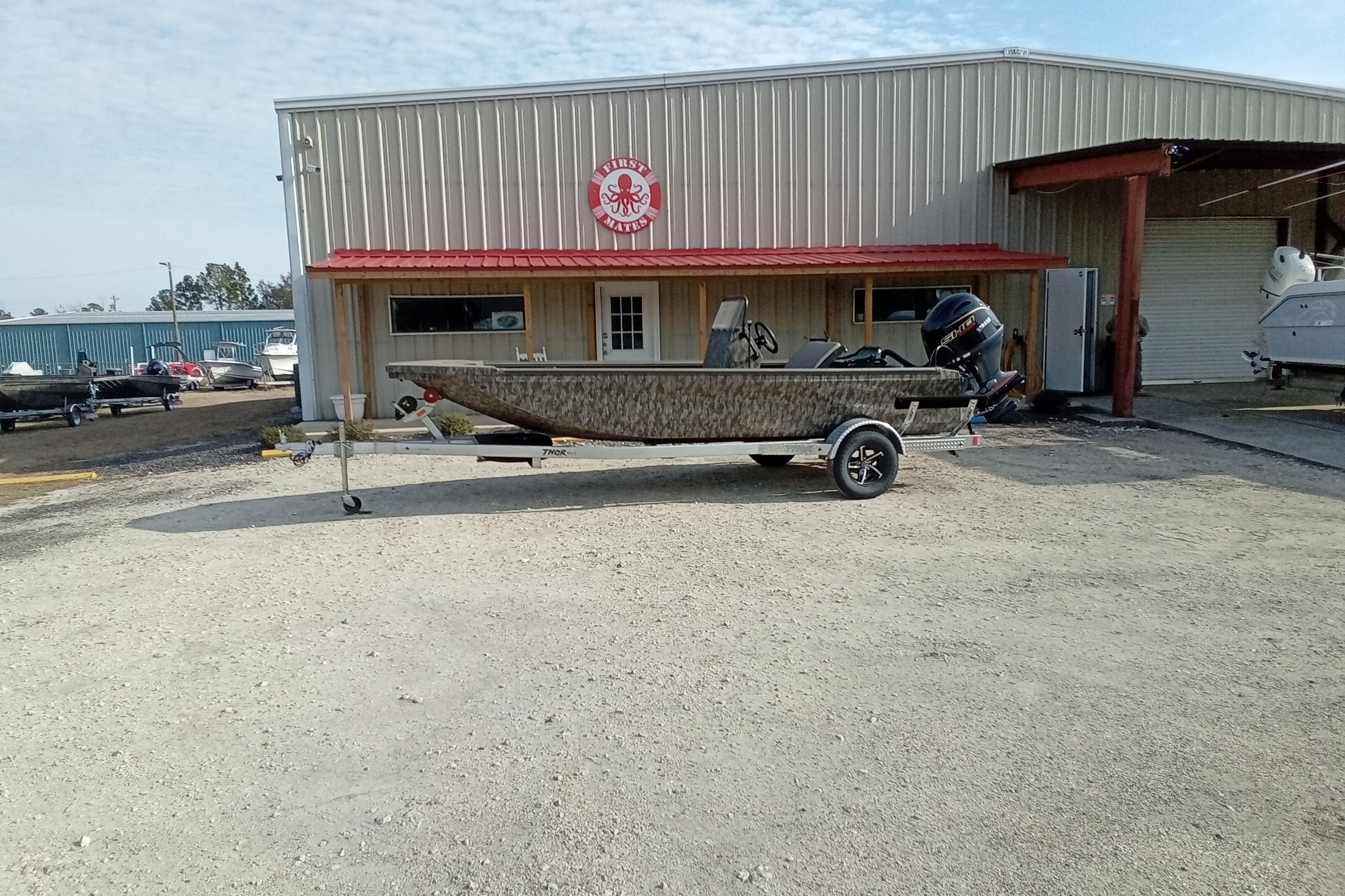 2026 Thor 1900 Low Country Elite boat on trailer outside dealership.