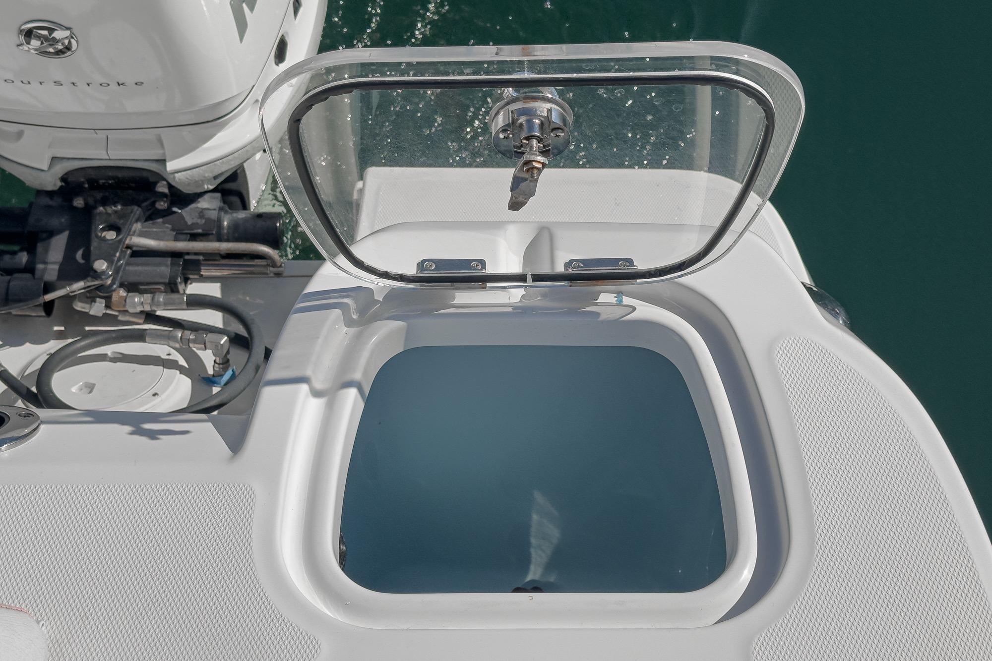 Livewell on a 2015 Boston Whaler 370 Outrage boat, open lid, clear water view.