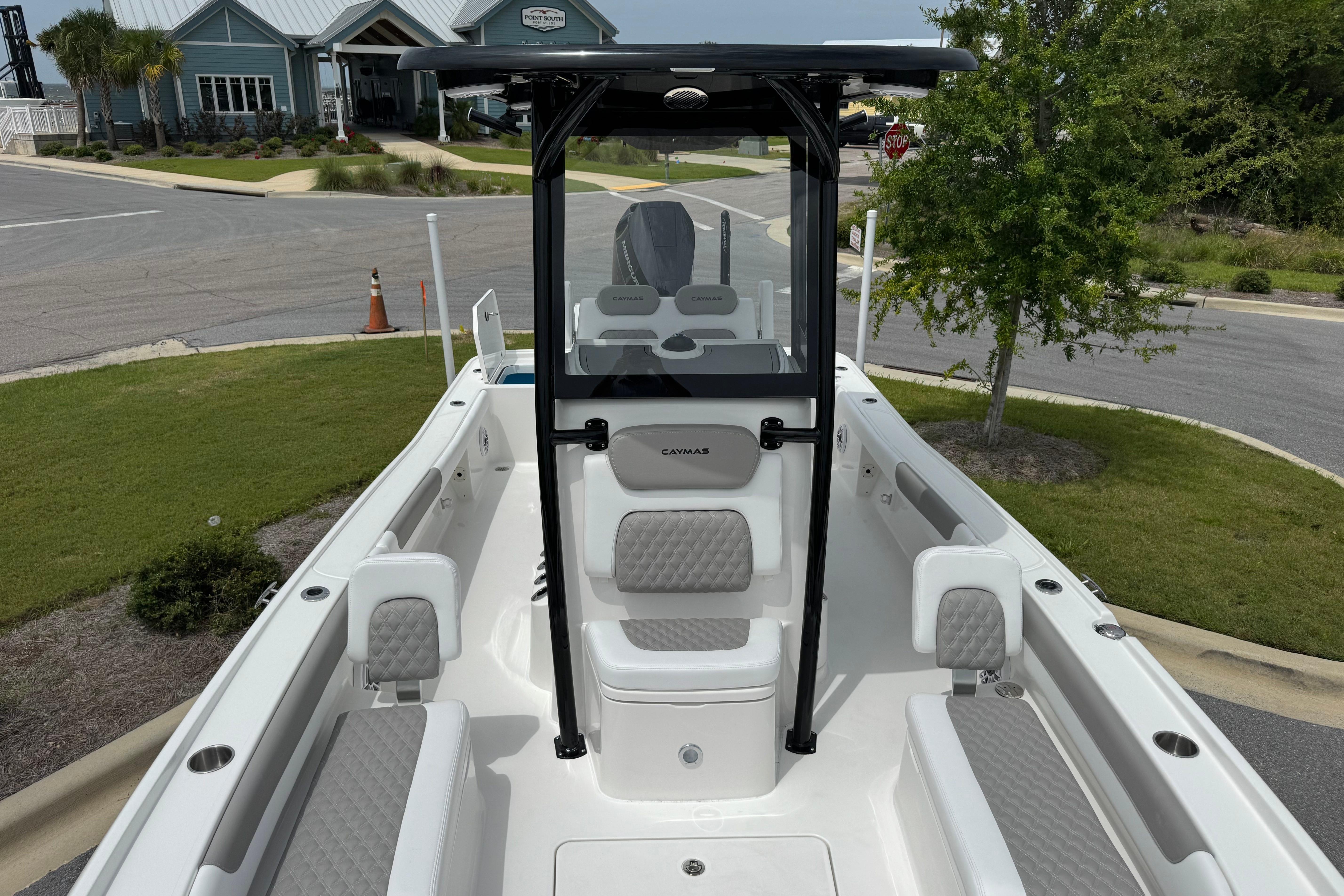 2027 Caymas 26 HB boat with sleek interior design, parked near a marina.