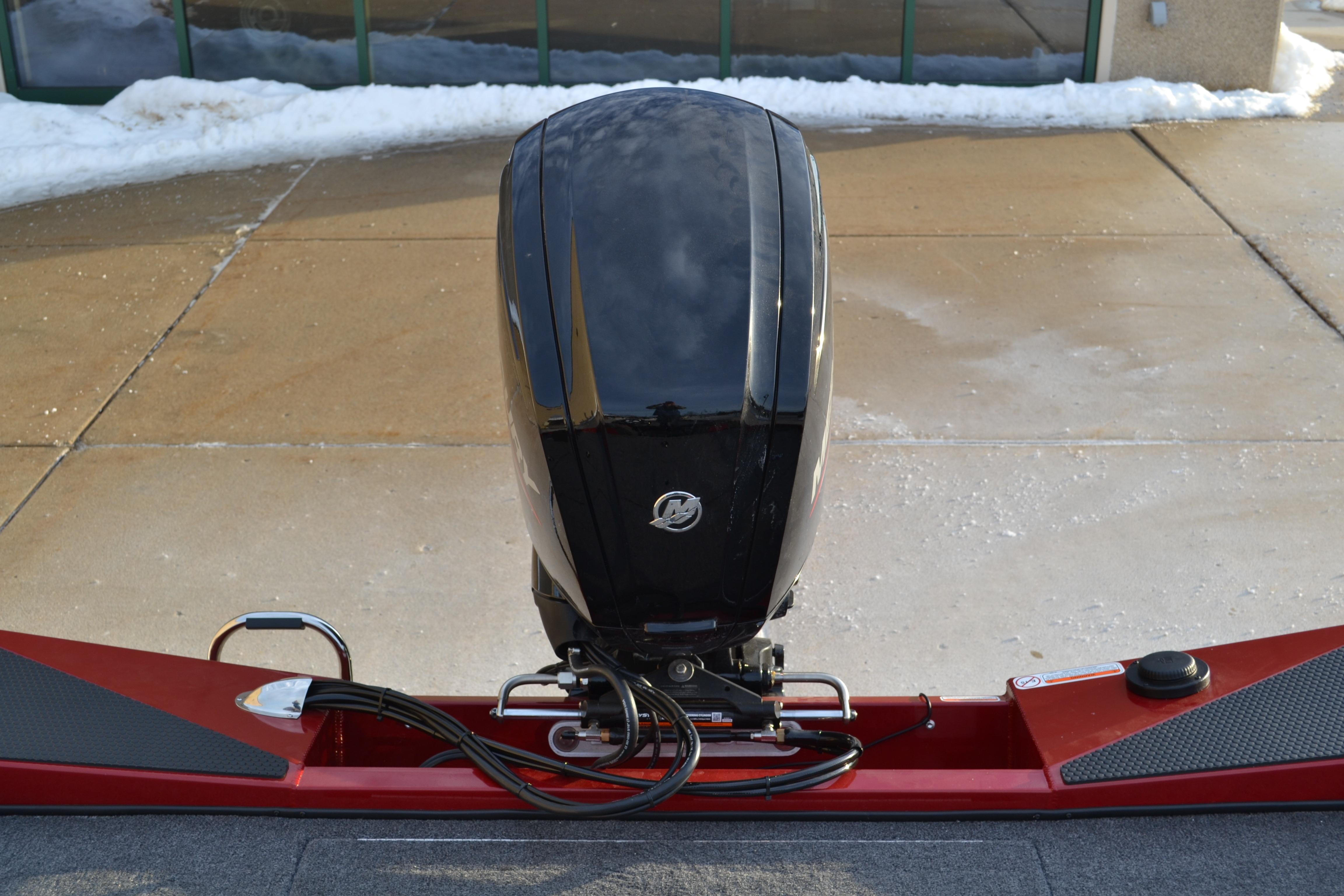 2026 Ranger RT188 boat with a sleek black outboard motor, parked on a snowy driveway.