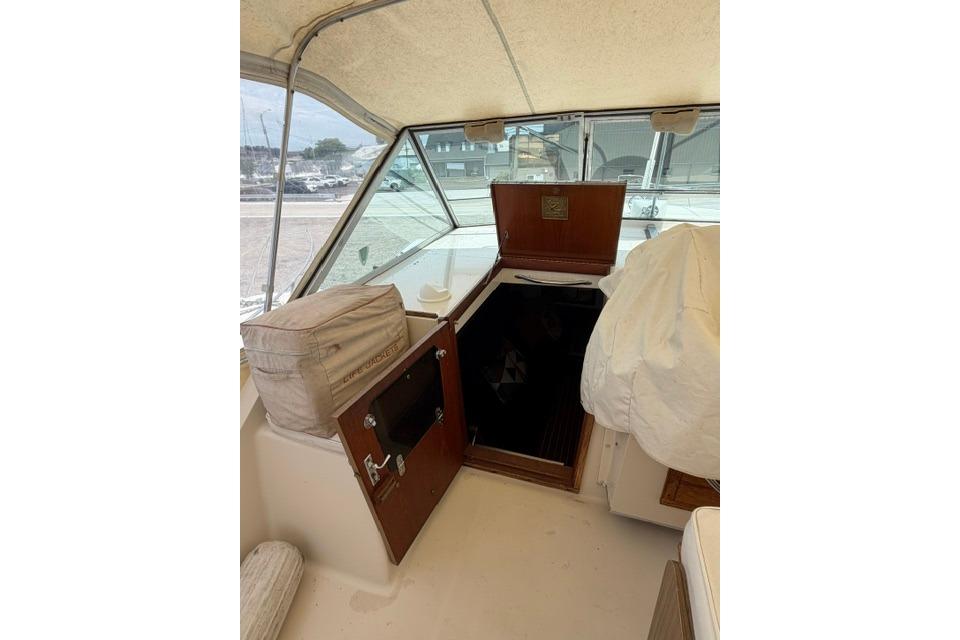 1980 Chris-Craft 381 Catalina cabin entrance with open hatch and cushioned seating.