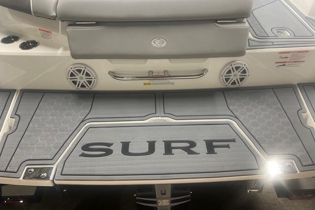 2025 Cobalt CS23 Surf boat deck with "SURF" branding and sleek design.