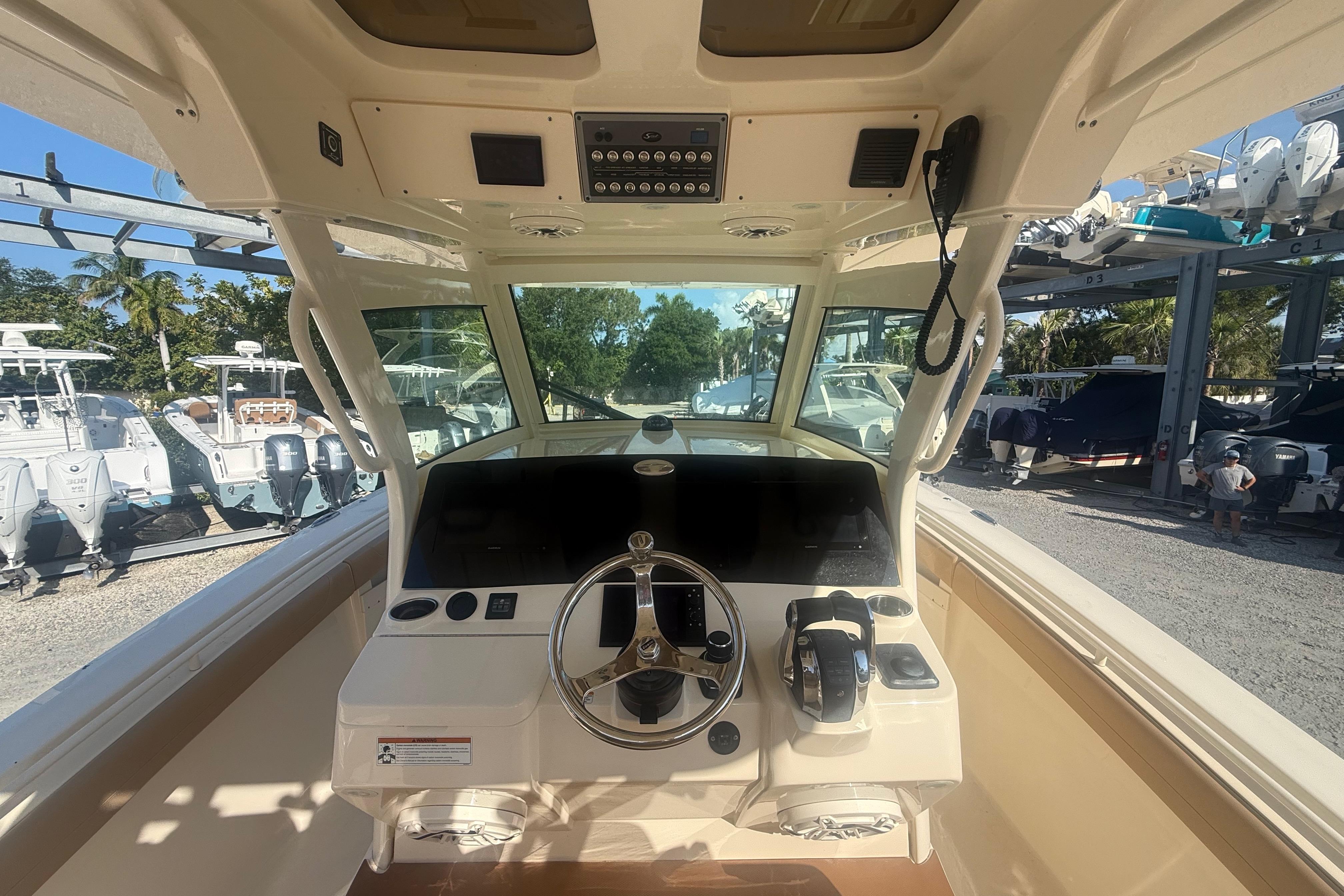 2022 Scout 355 LXF boat helm with steering wheel and control panel.
