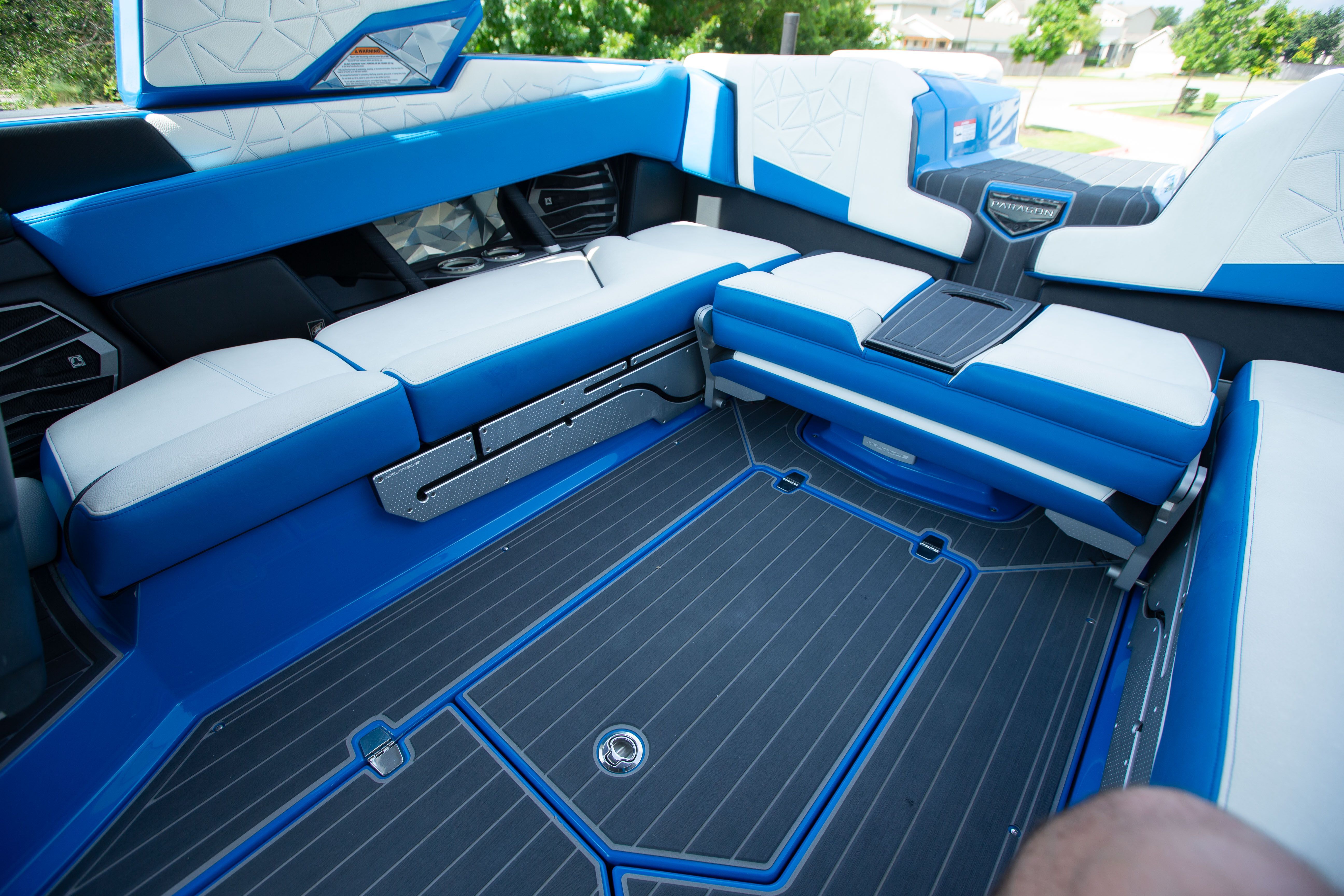 Interior of a modern boat with blue and white seating.