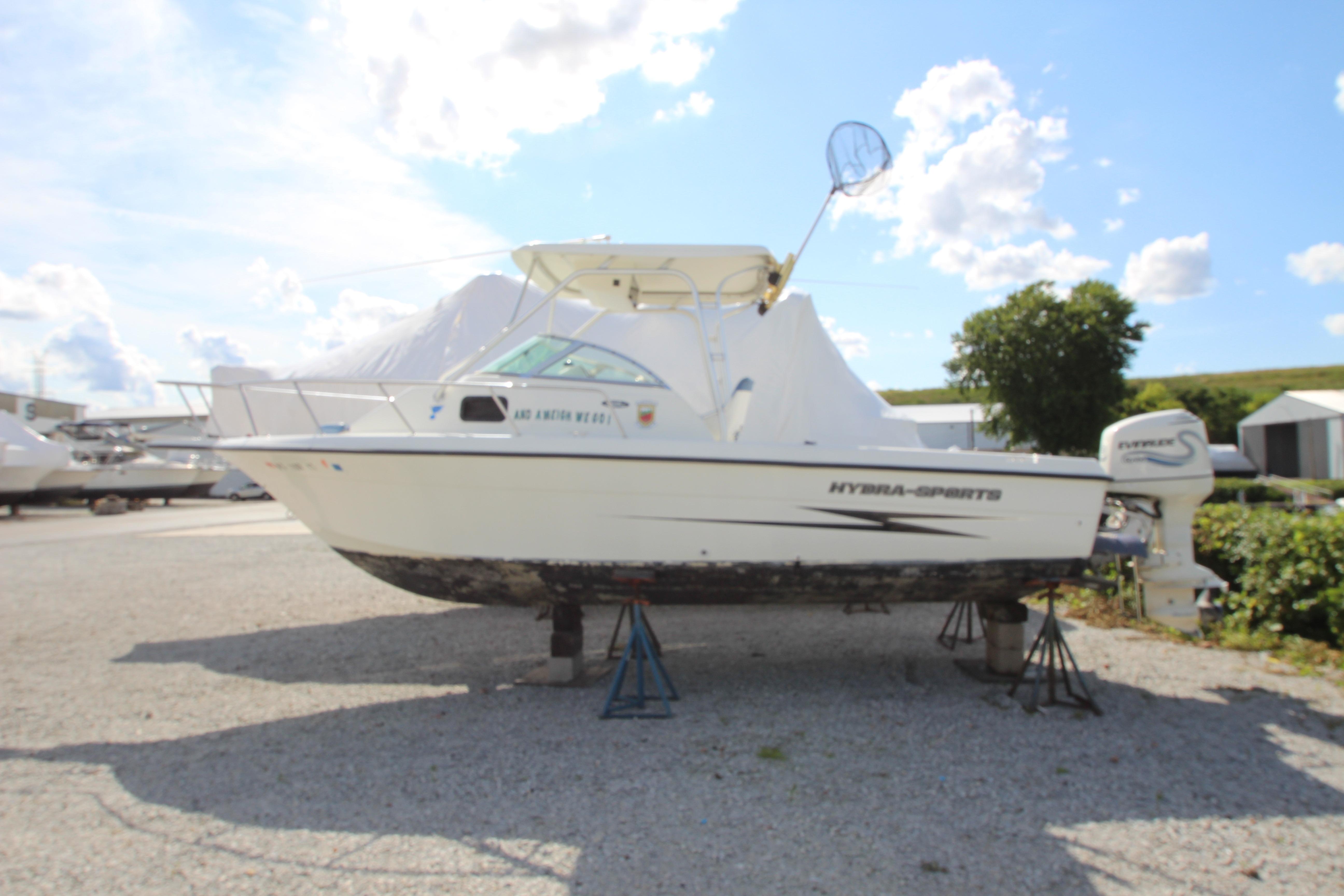 2002 Hydra-Sports 230 WA boat on stands, outdoor storage, clear sky background.