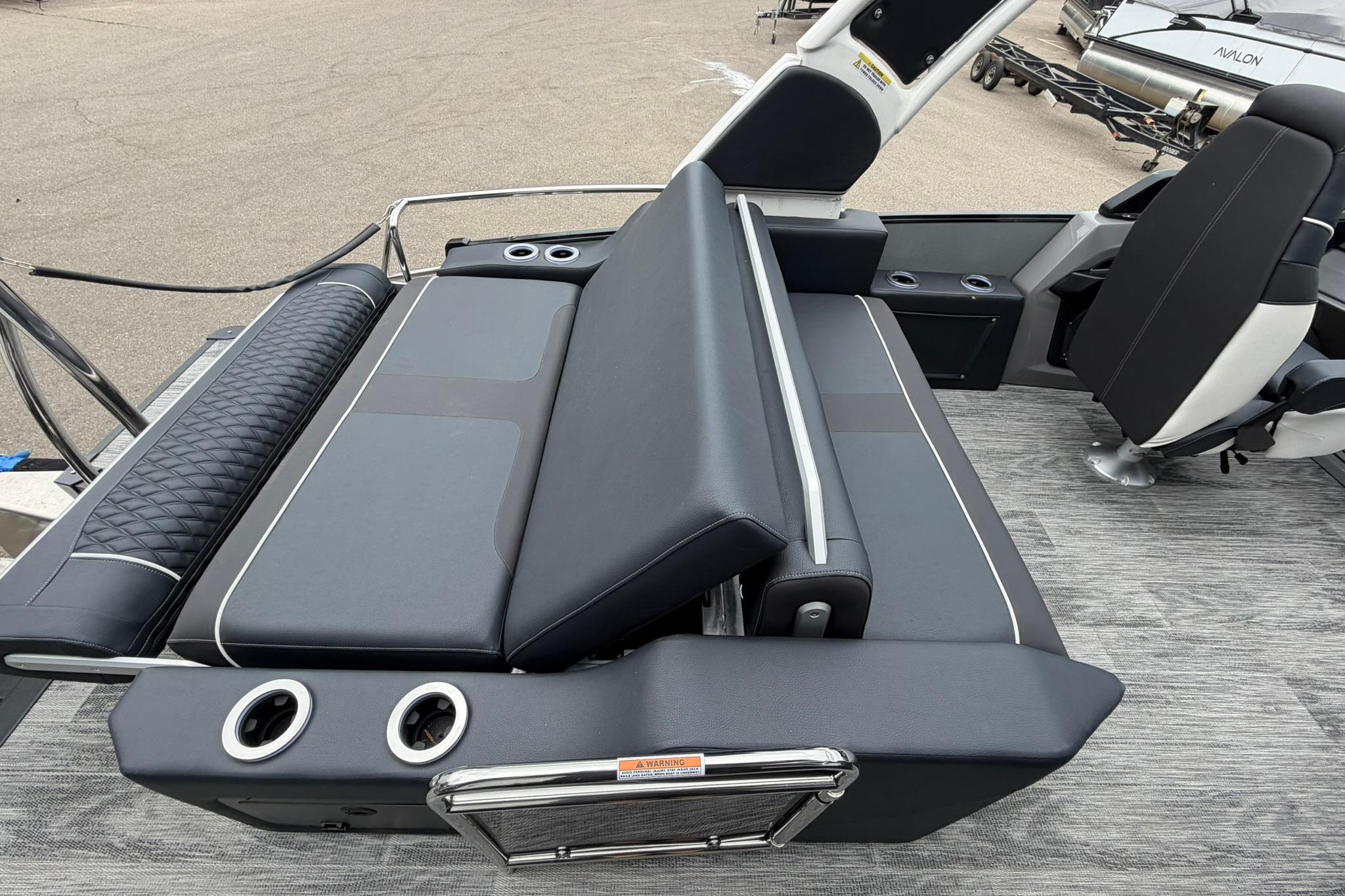 2026 Avalon Excalibur LTD Flex Lounge Windshield boat interior with luxurious seating and cup holders.