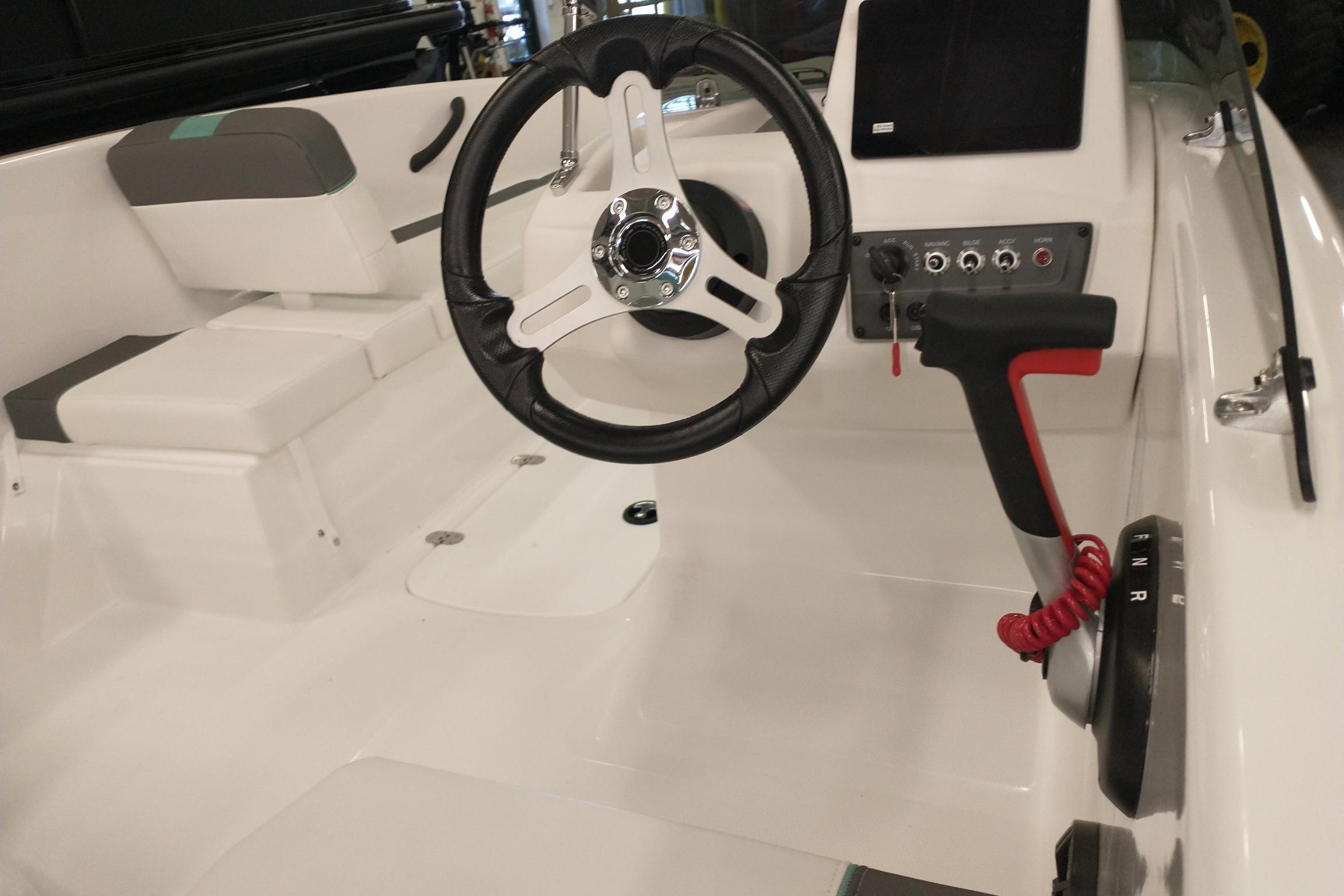 2026 Tahoe T16 boat interior with steering wheel and control panel.