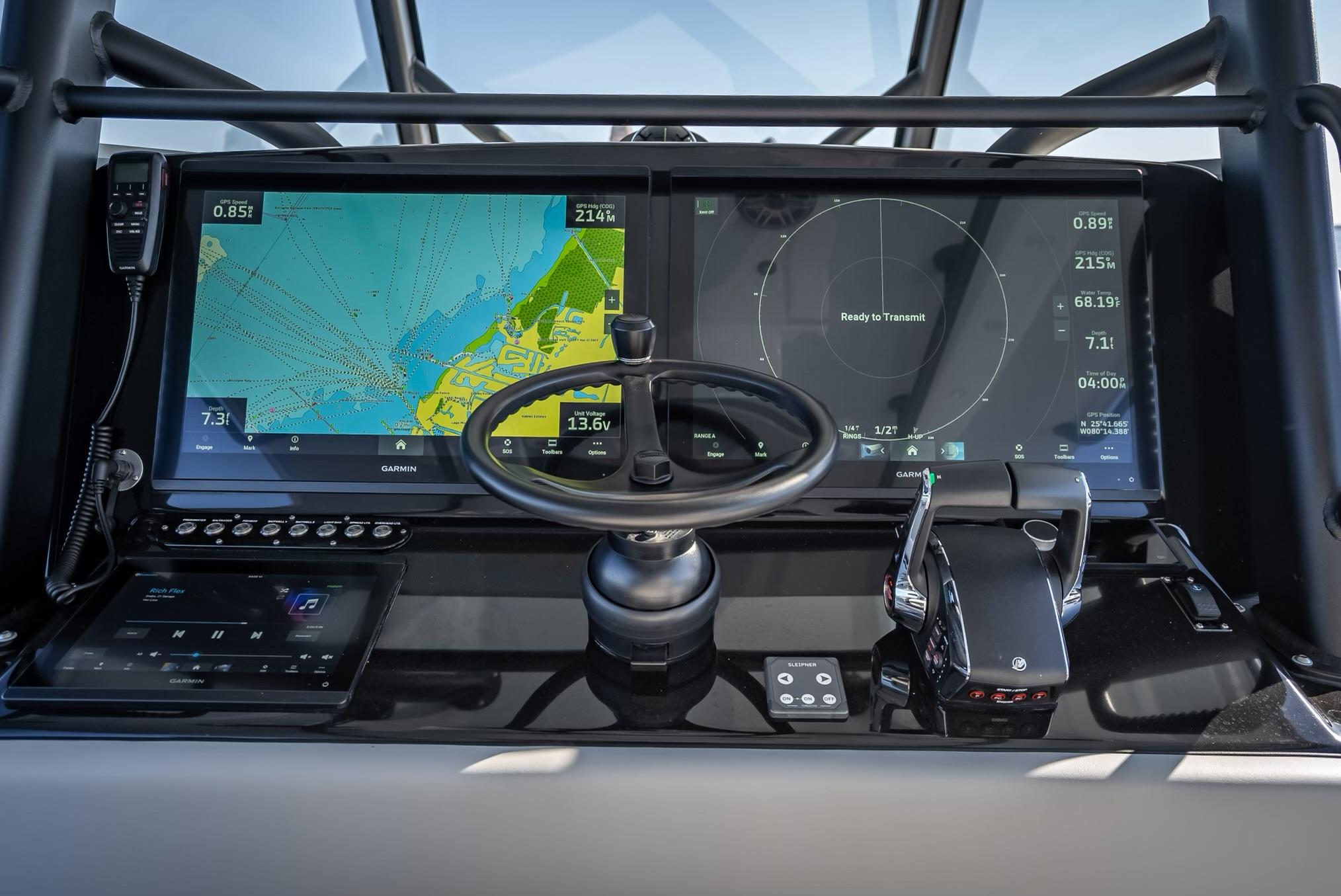 2024 Yellowfin 42 boat dashboard with navigation screens and steering wheel.