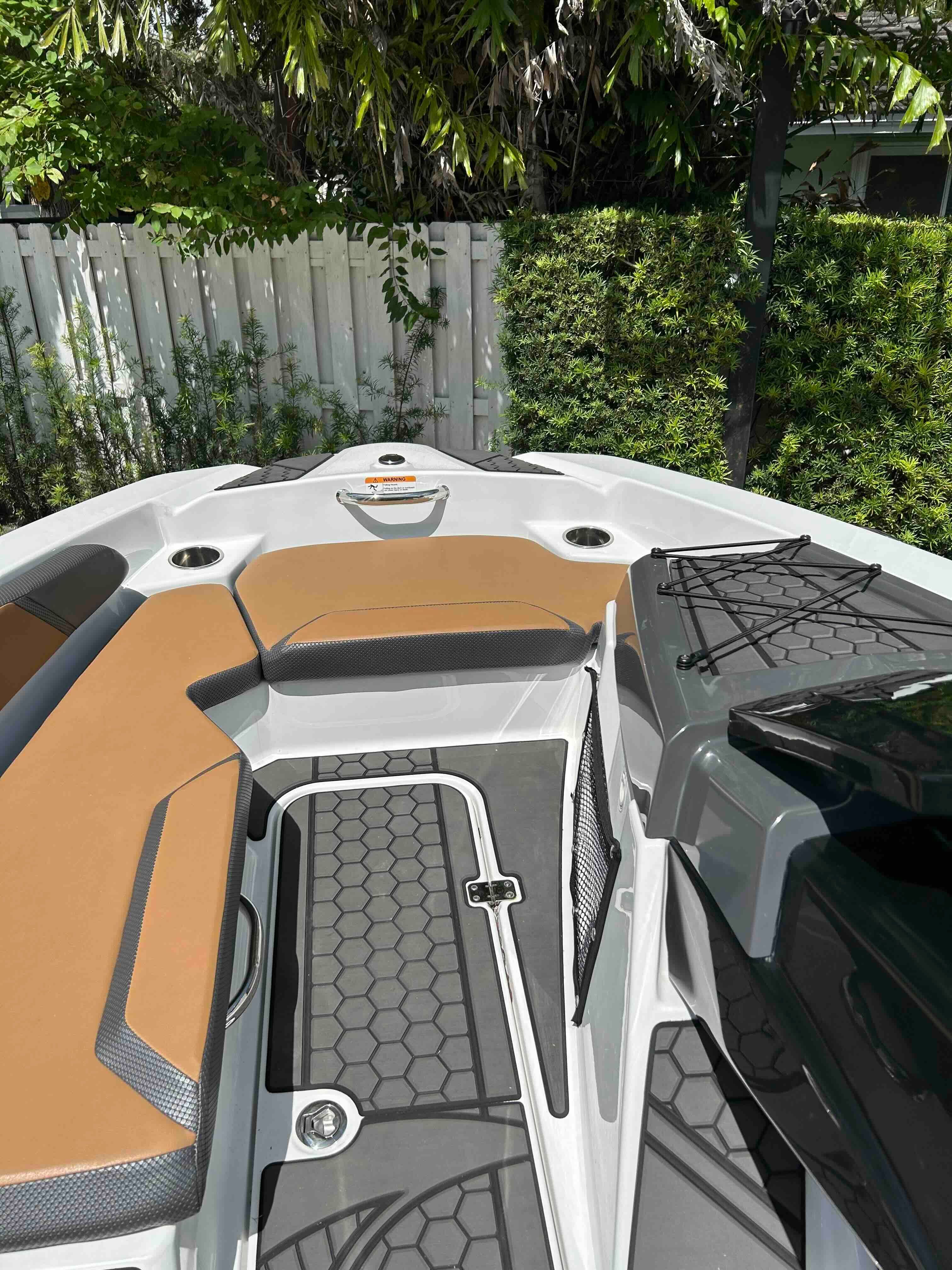 The image shows the deck of a 2022 Scarab 165 ID boat with modern seating.