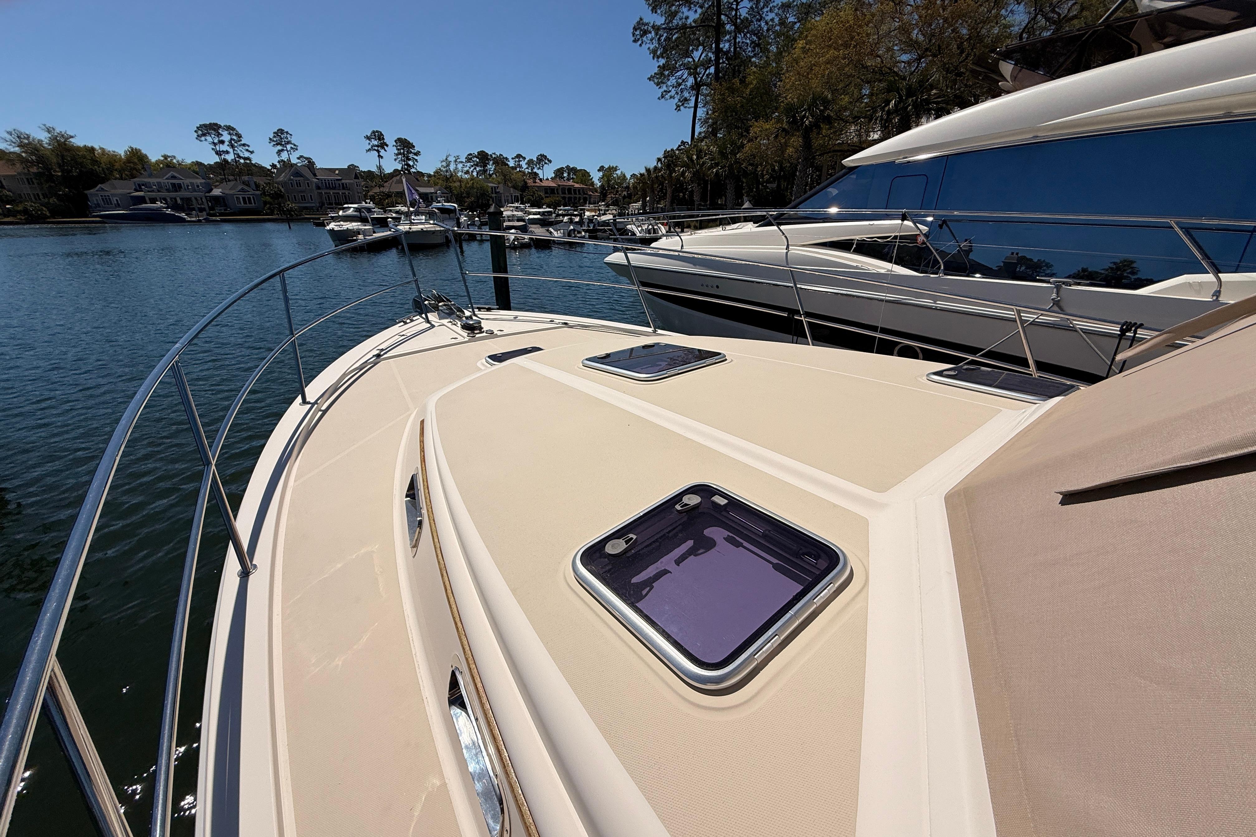 2022 Sabre 38 Salon Express yacht docked in a serene marina setting.