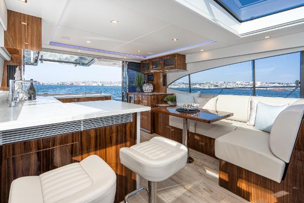 Luxurious interior of 2021 Riviera 5400 Sport Yacht with ocean view.
