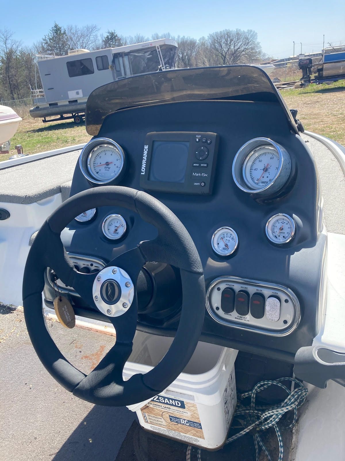 The image shows the helm of a 2011 Nitro Z-7 boat with multiple gauges and a steering wheel.