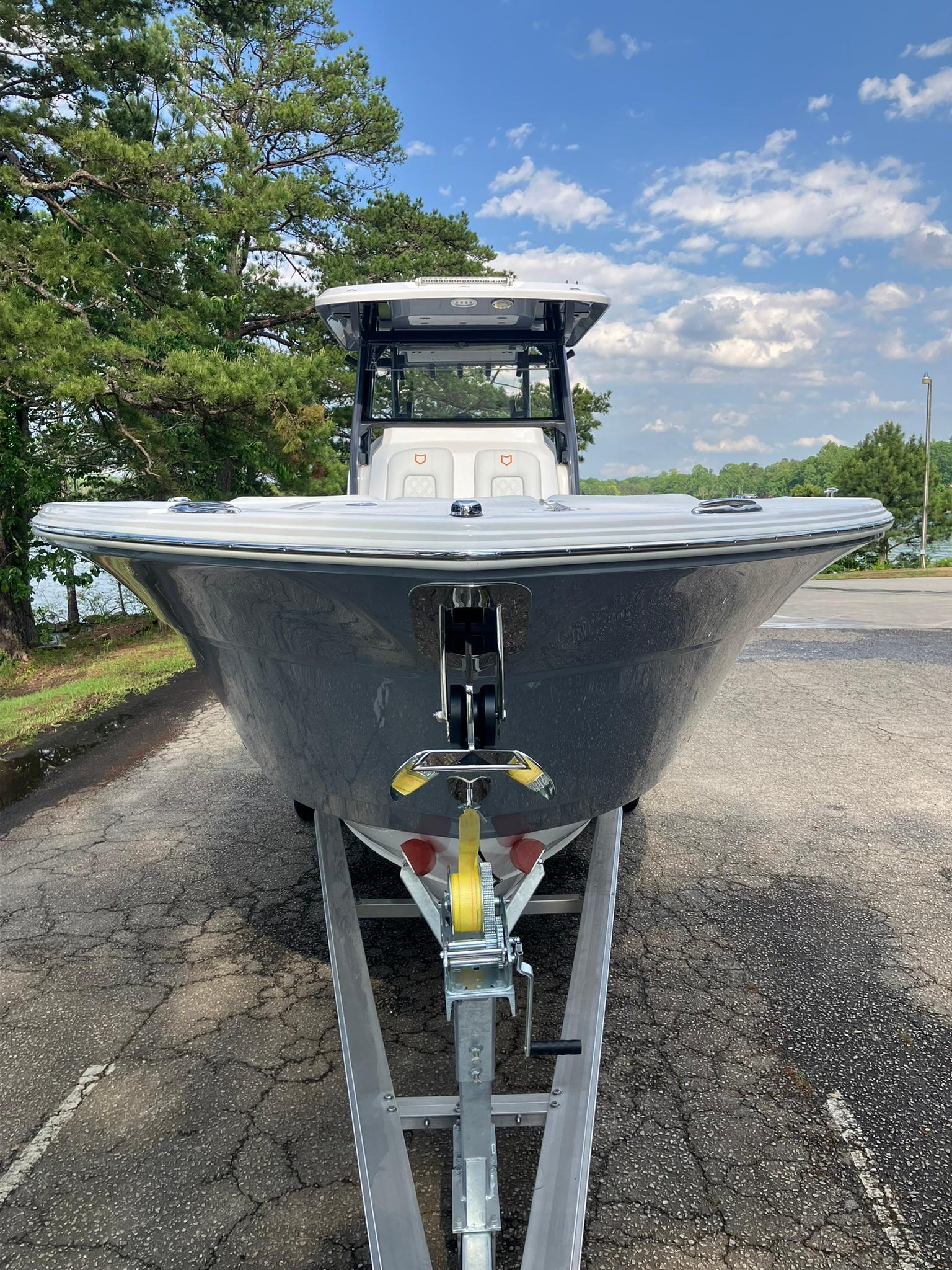 2025 Sea Fox 328 Commander boat on trailer, parked outdoors under a blue sky.