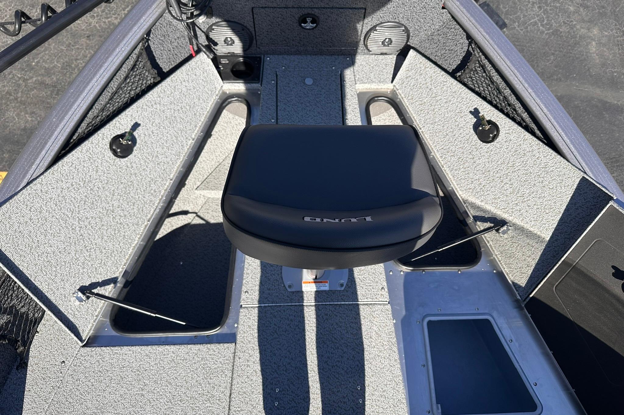 2026 Lund 1875 Impact XS SS boat interior with seating and storage compartments.