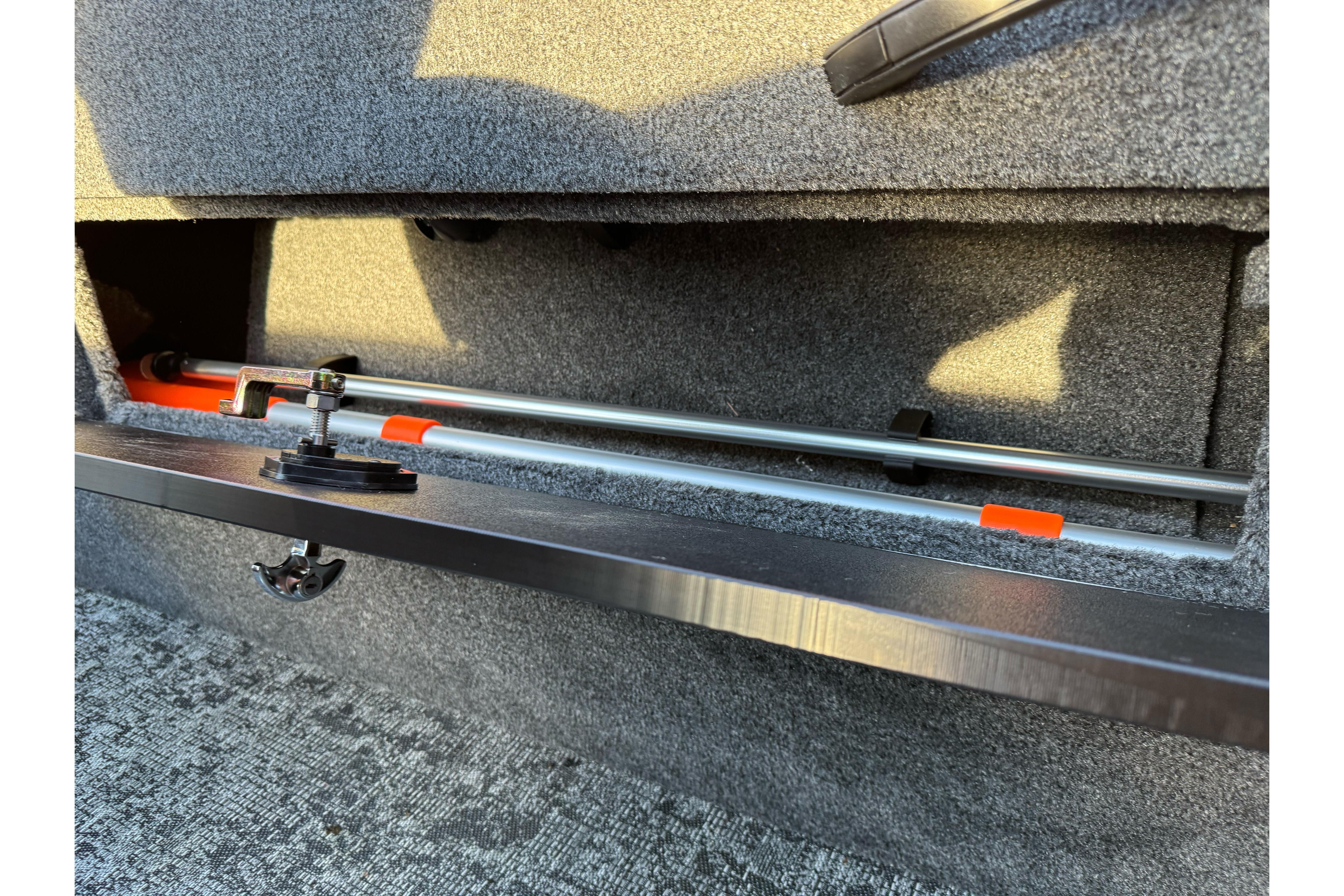 Storage compartment in 2026 Tracker Targa V-18 WT boat, featuring secure rod holders.