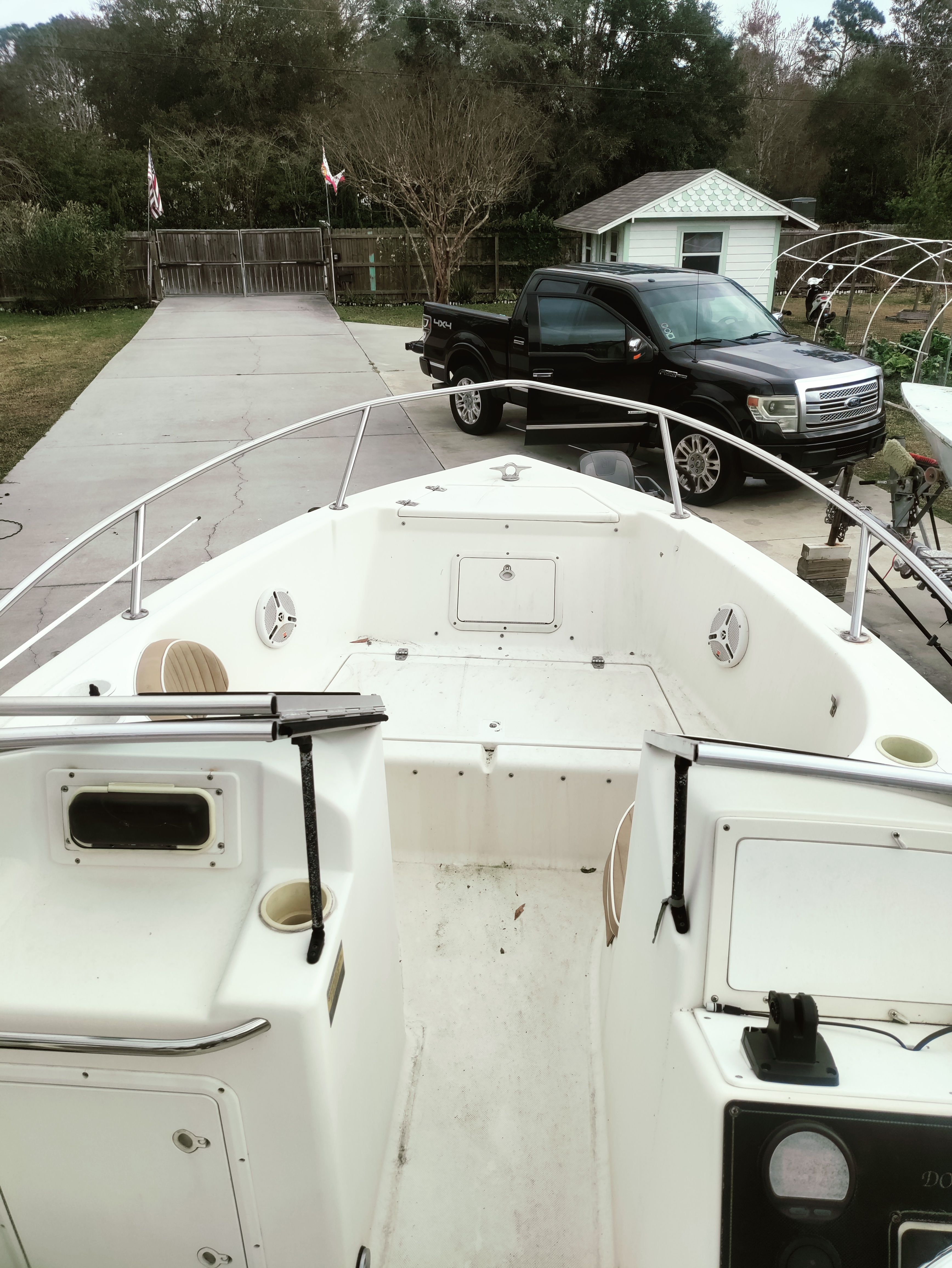 Scout 202 boat from 2000 on a trailer in a driveway.