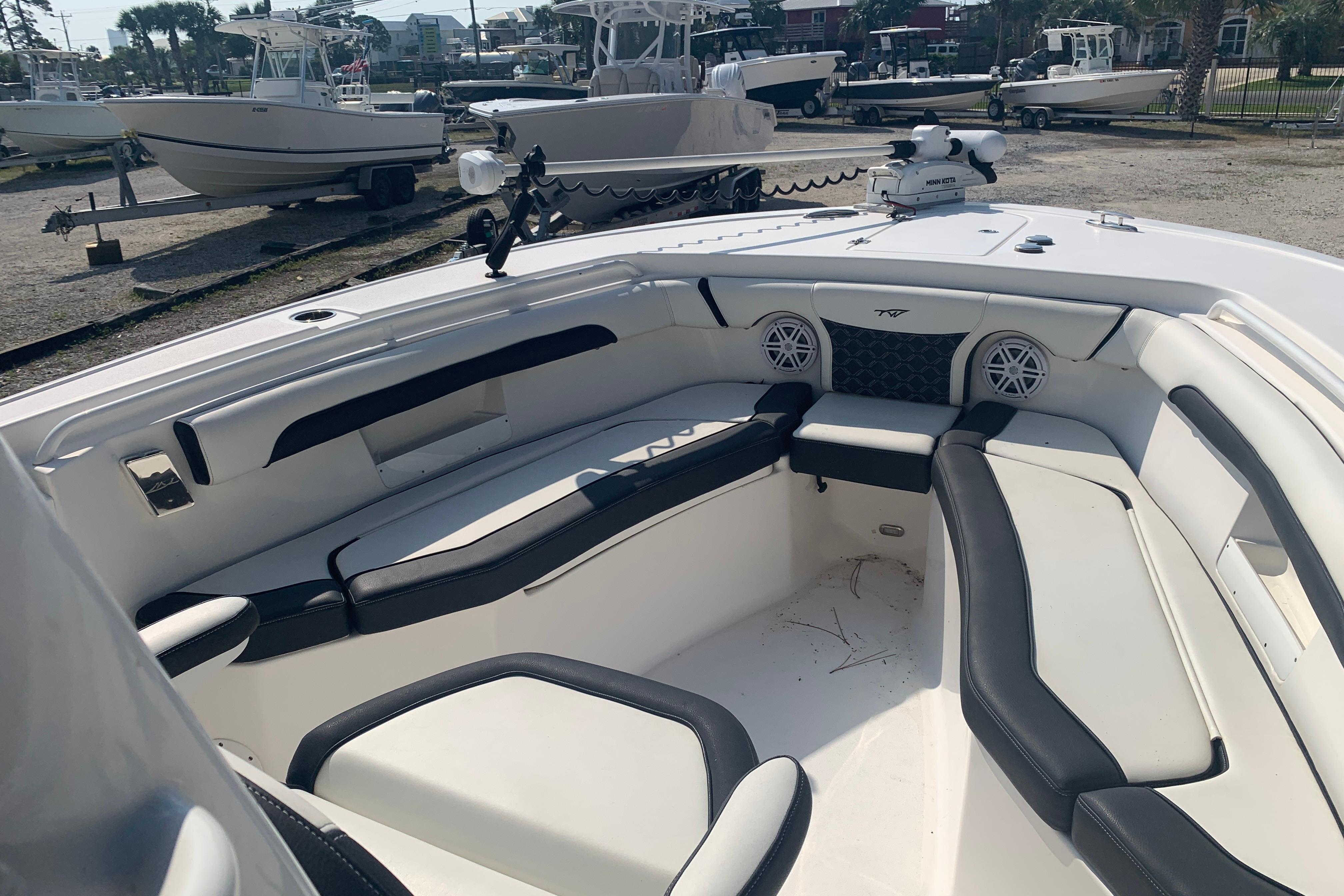 2021 Tidewater 256 CC Adventure boat interior with cushioned seating and speakers.