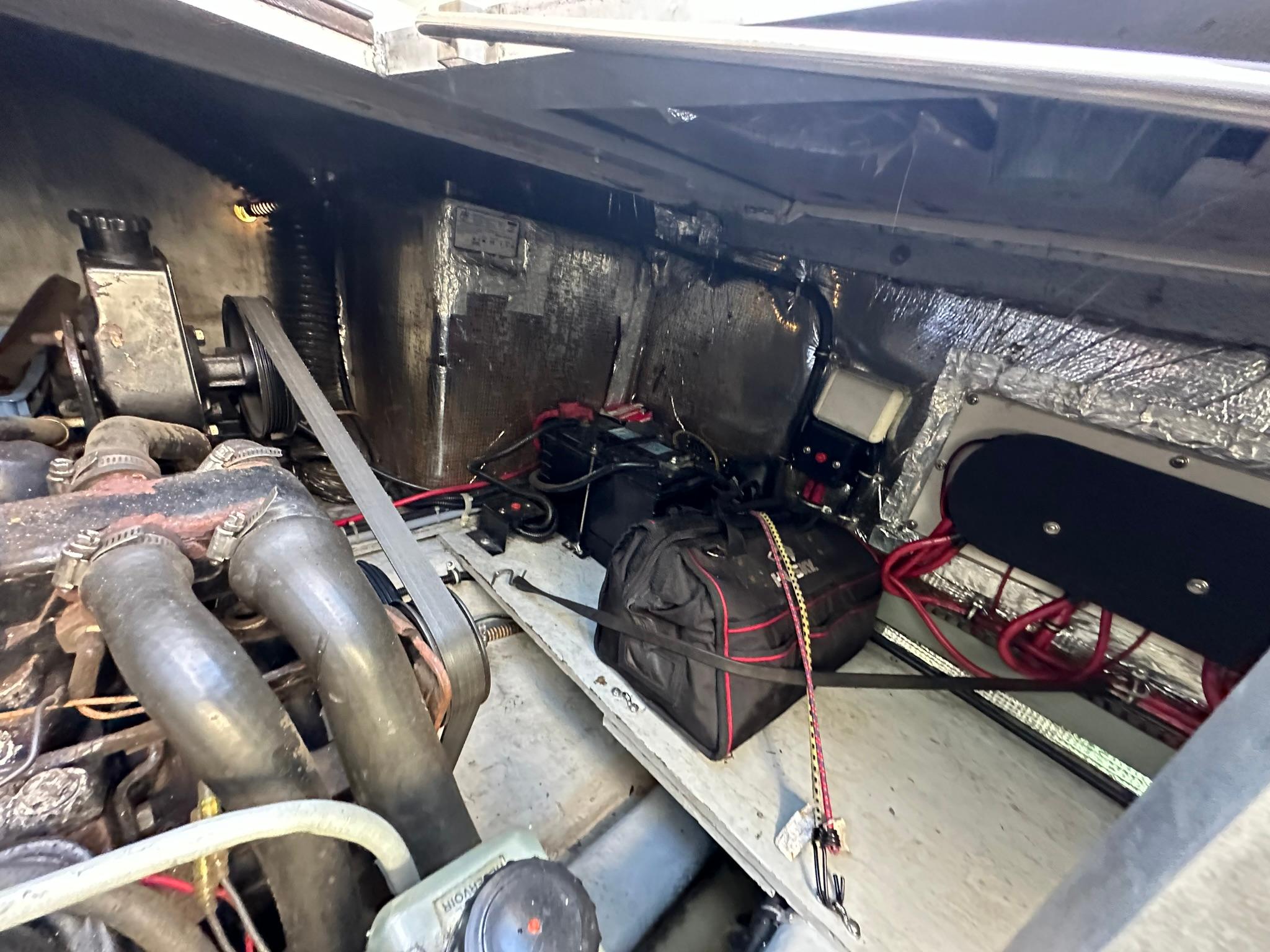 Engine compartment of a 1997 Regal 292 Commodore boat, showing mechanical components and wiring.