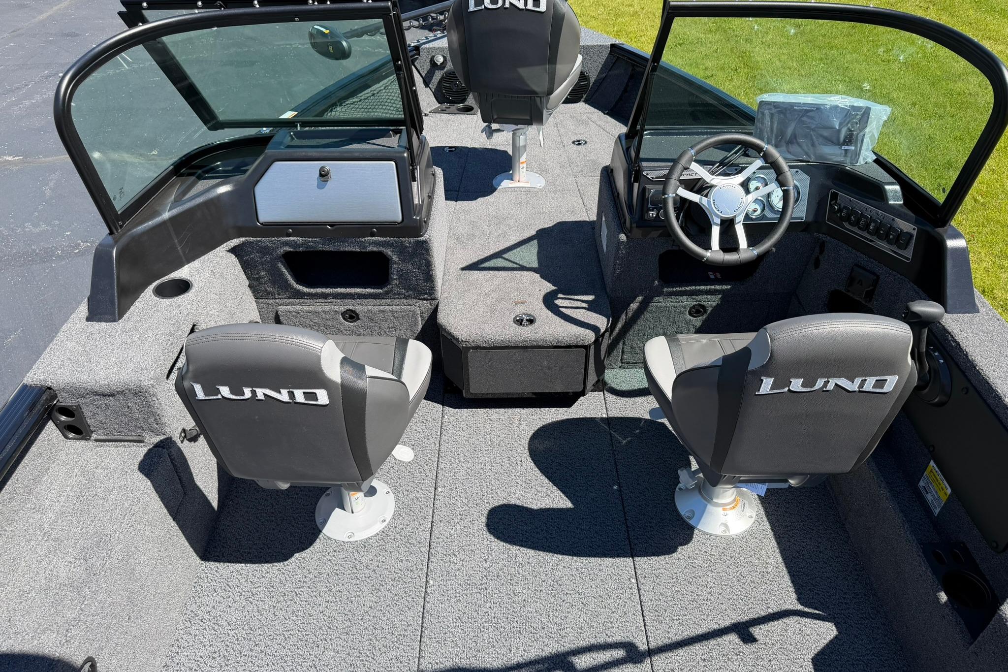 2027 Lund 1775 Impact XS Sport boat interior with seating and steering wheel.