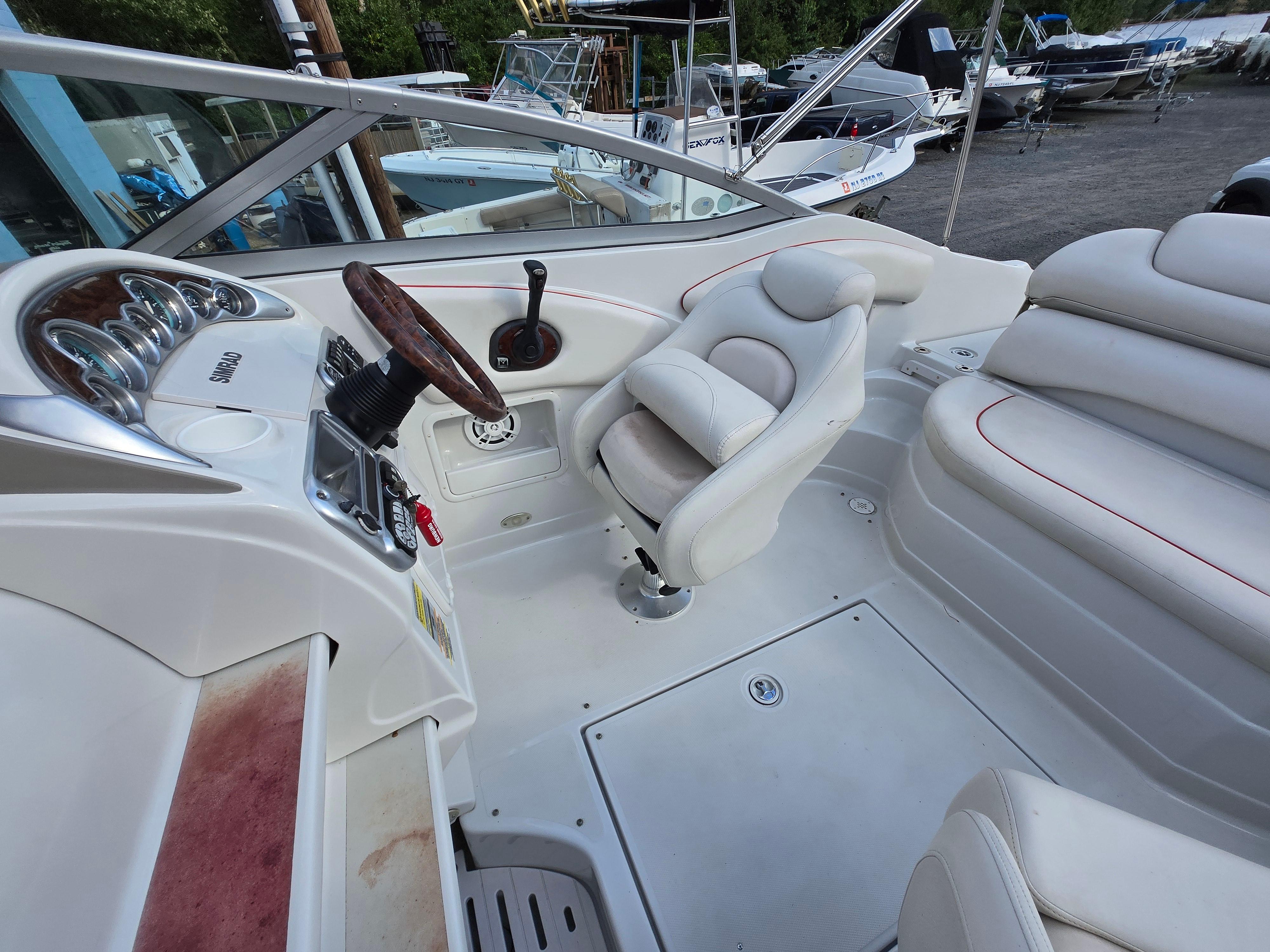 2006 Crownline 255 CCR boat interior with white seating and steering wheel.