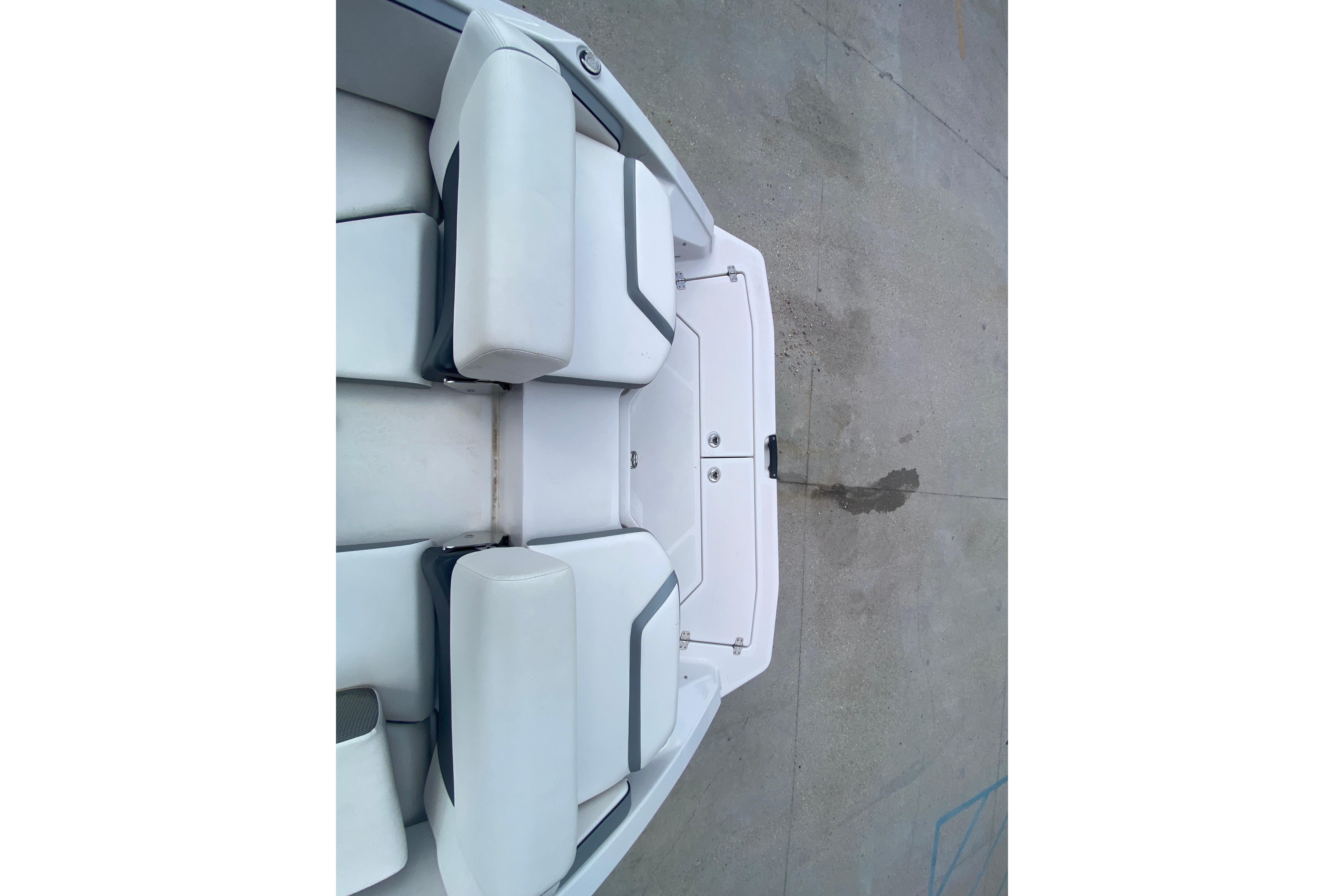 2018 Scarab 215 G boat interior with white cushioned seating.