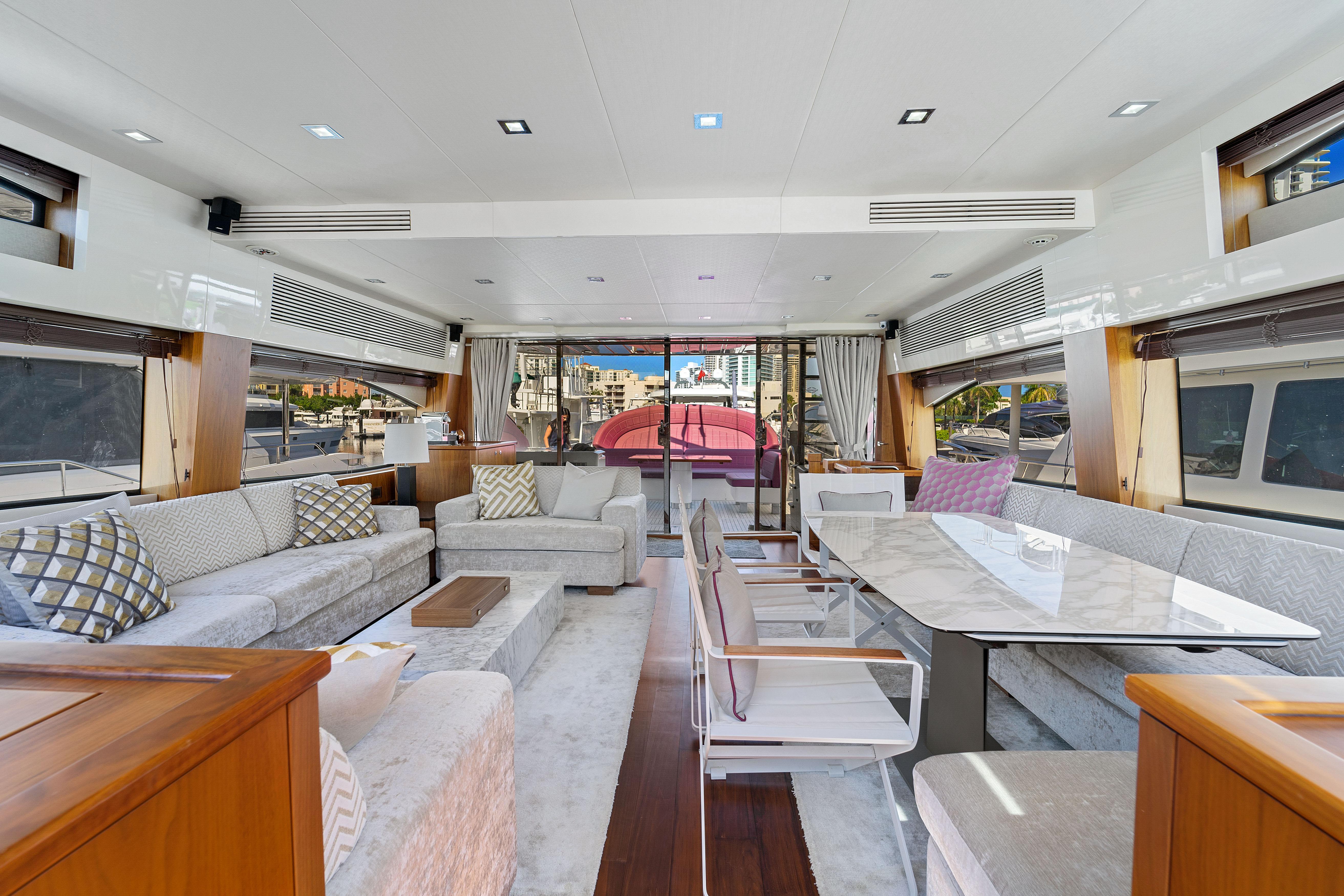 Luxurious interior of a 2013 Sunseeker Predator 84 yacht with elegant seating and dining area.