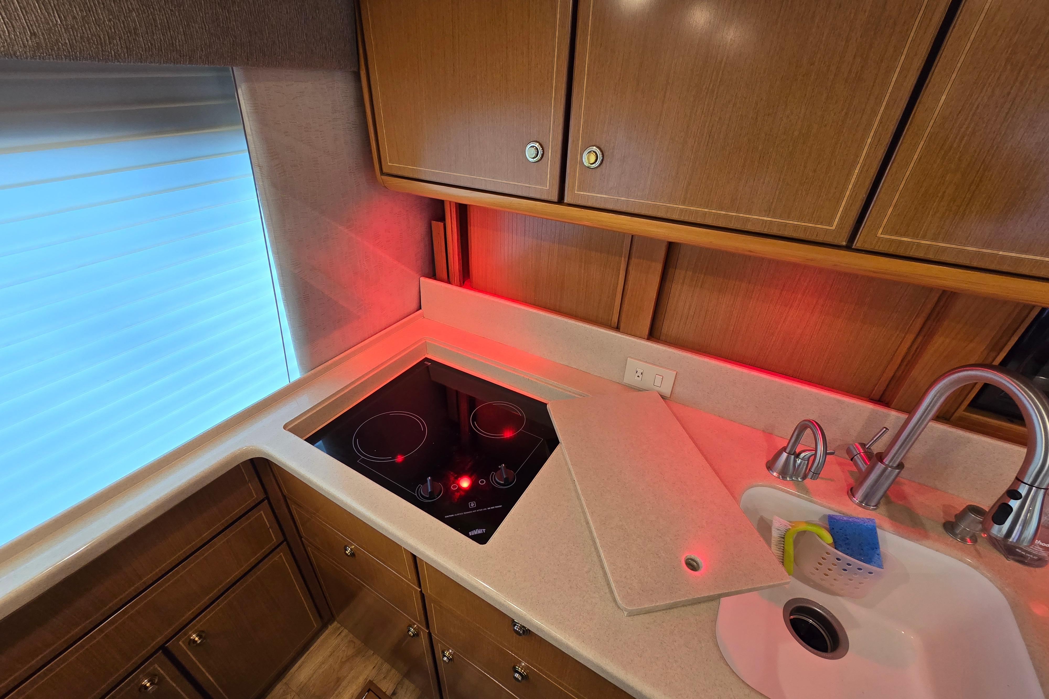 Kitchen area of a 2004 Ocean Yachts 50 Super Sport with stove and sink.