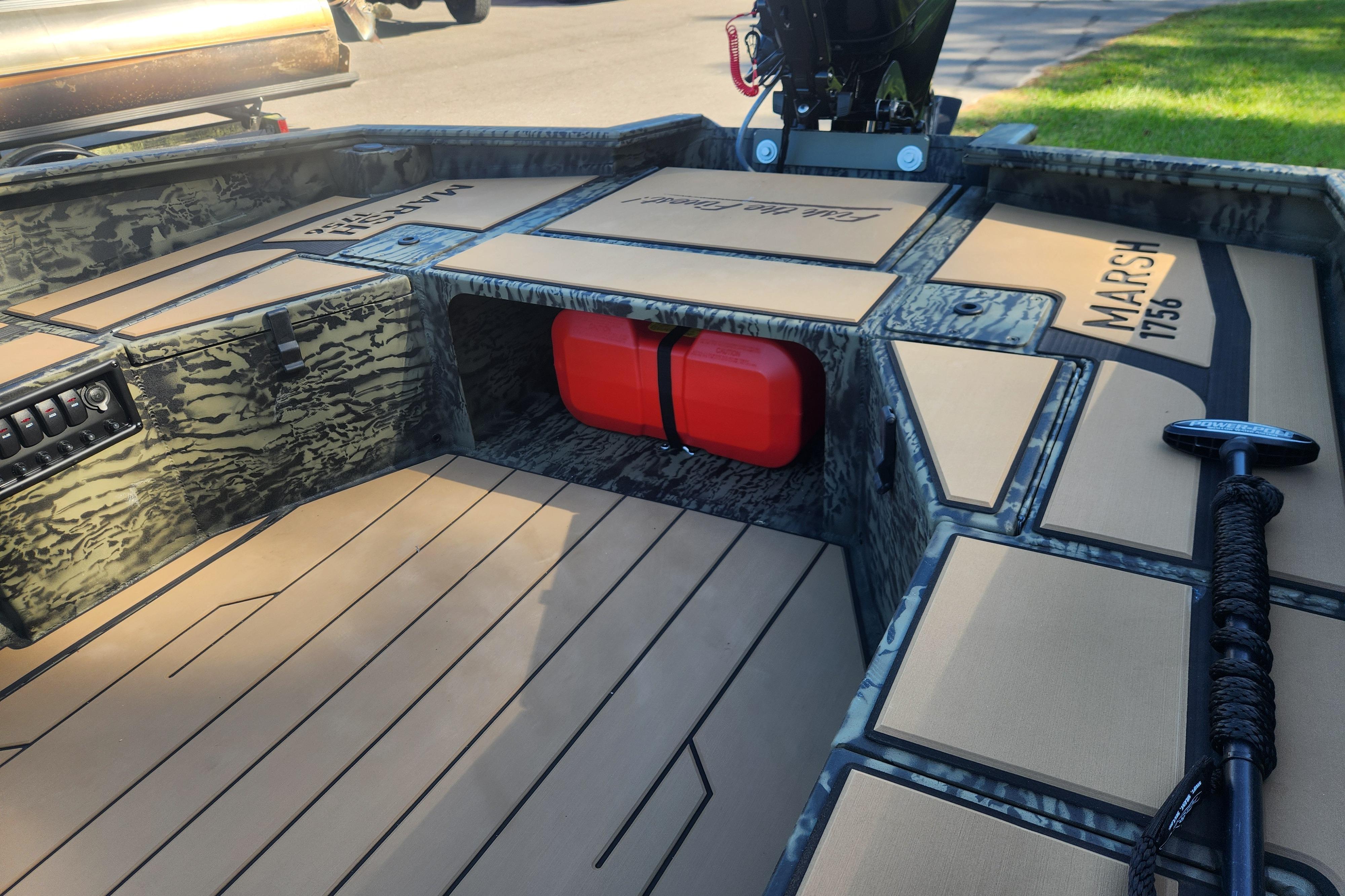 2026 Tracker Grizzly 1756 T Marsh boat interior with camouflage design and red fuel tank.