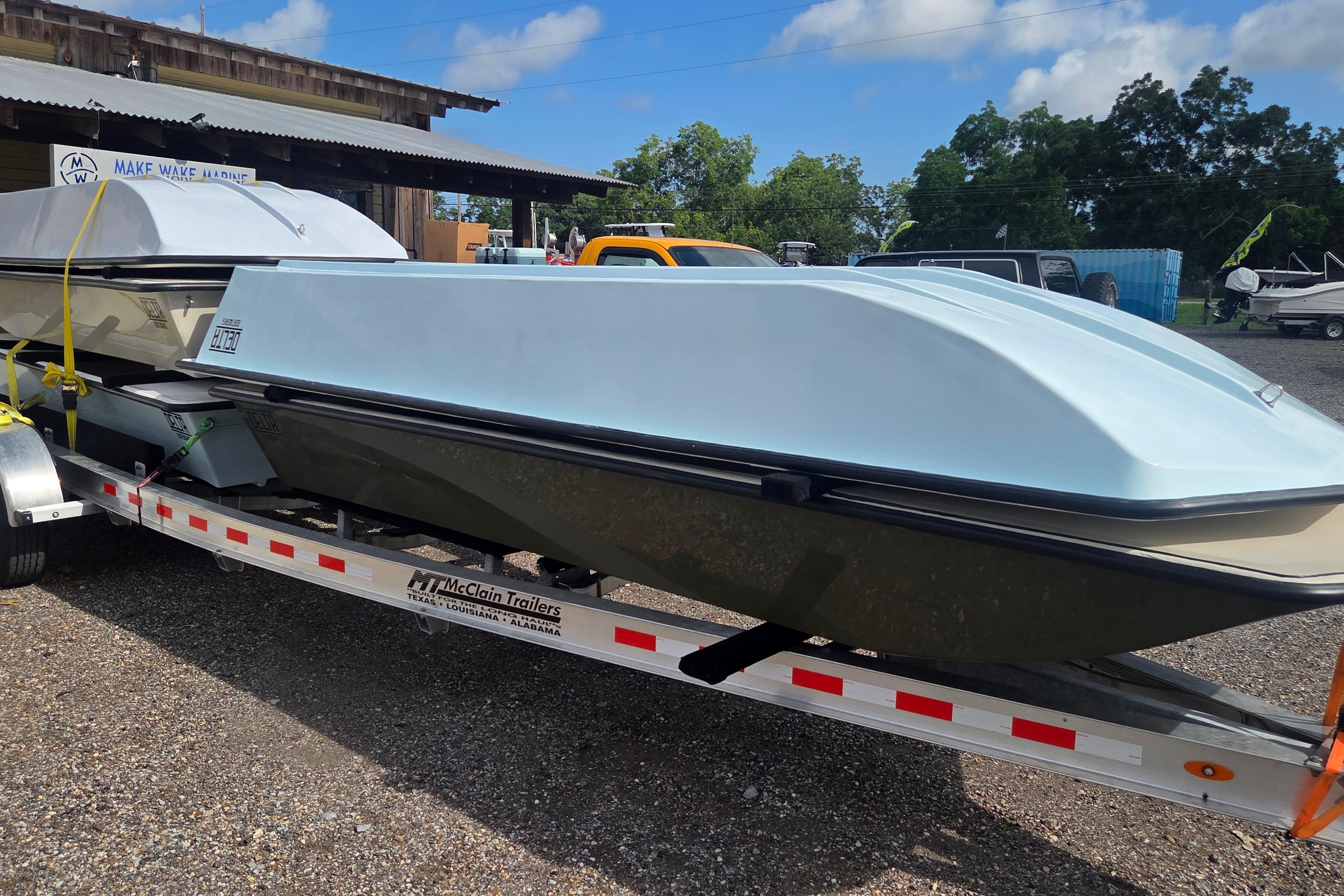 2027 Delta Boatworks 1550 on trailer, parked outdoors under blue sky.