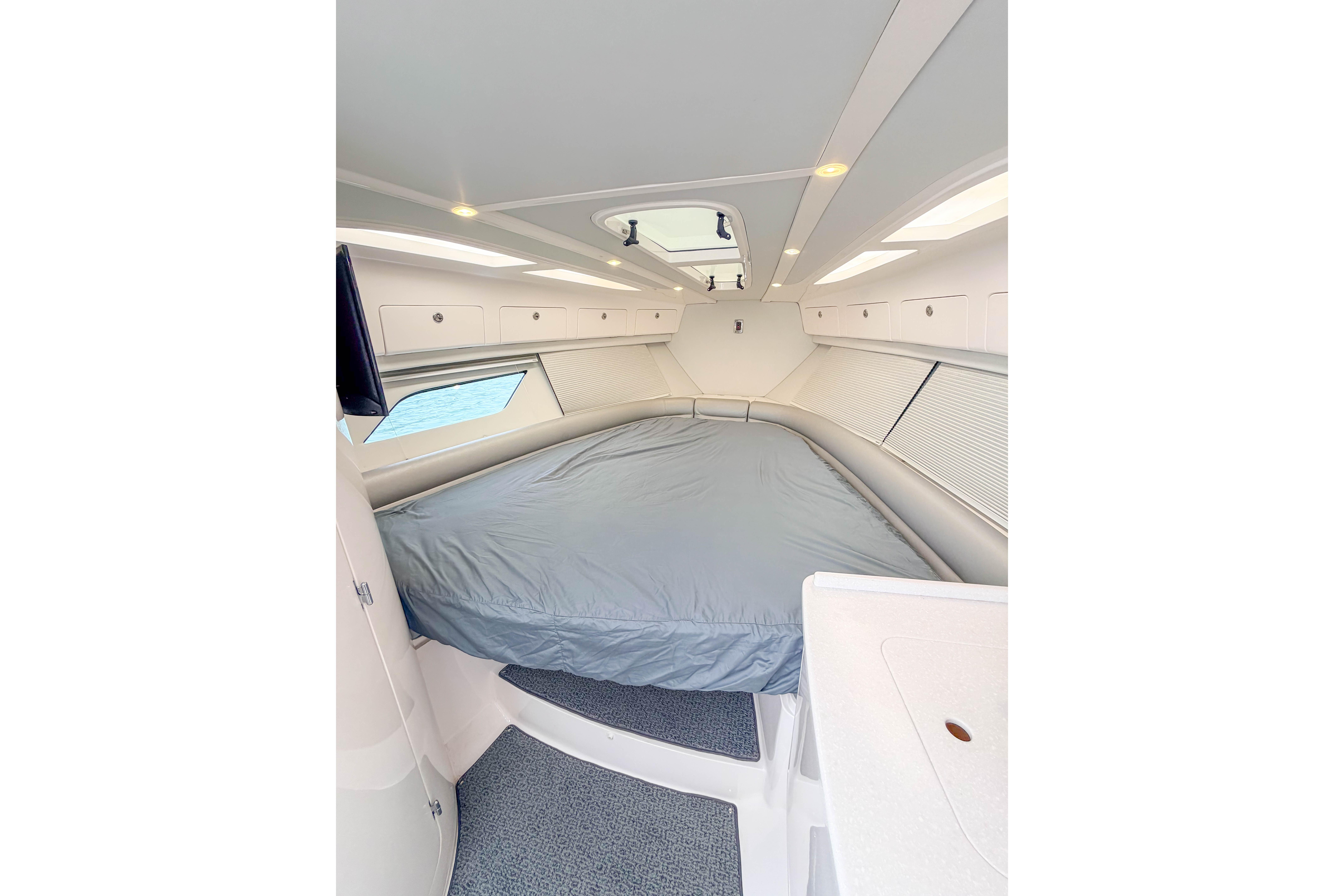 2021 Intrepid 409 Valor cabin interior with bed, modern design, and ample storage.