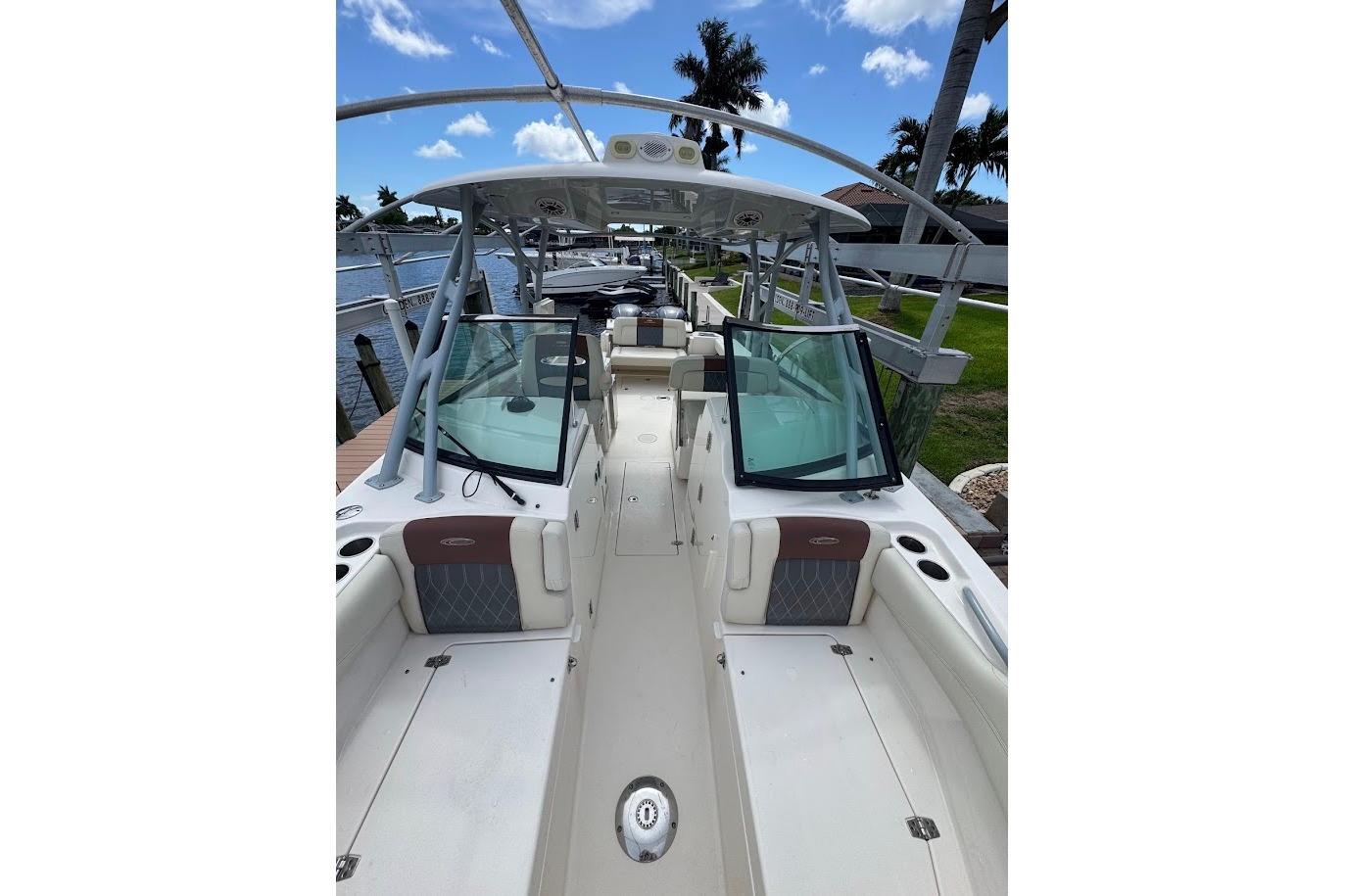 2020 Cobia 280 Dual Console boat docked, featuring spacious seating and sleek design.