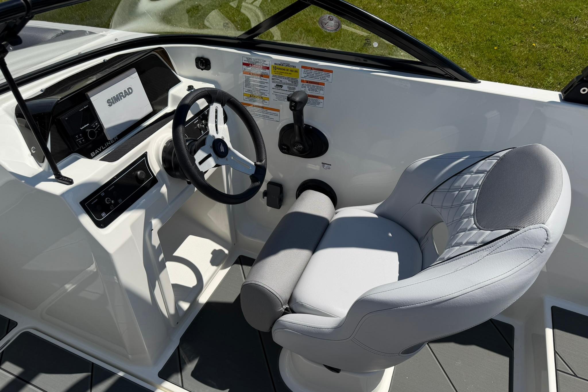2026 Bayliner D20 boat cockpit with steering wheel and modern controls.