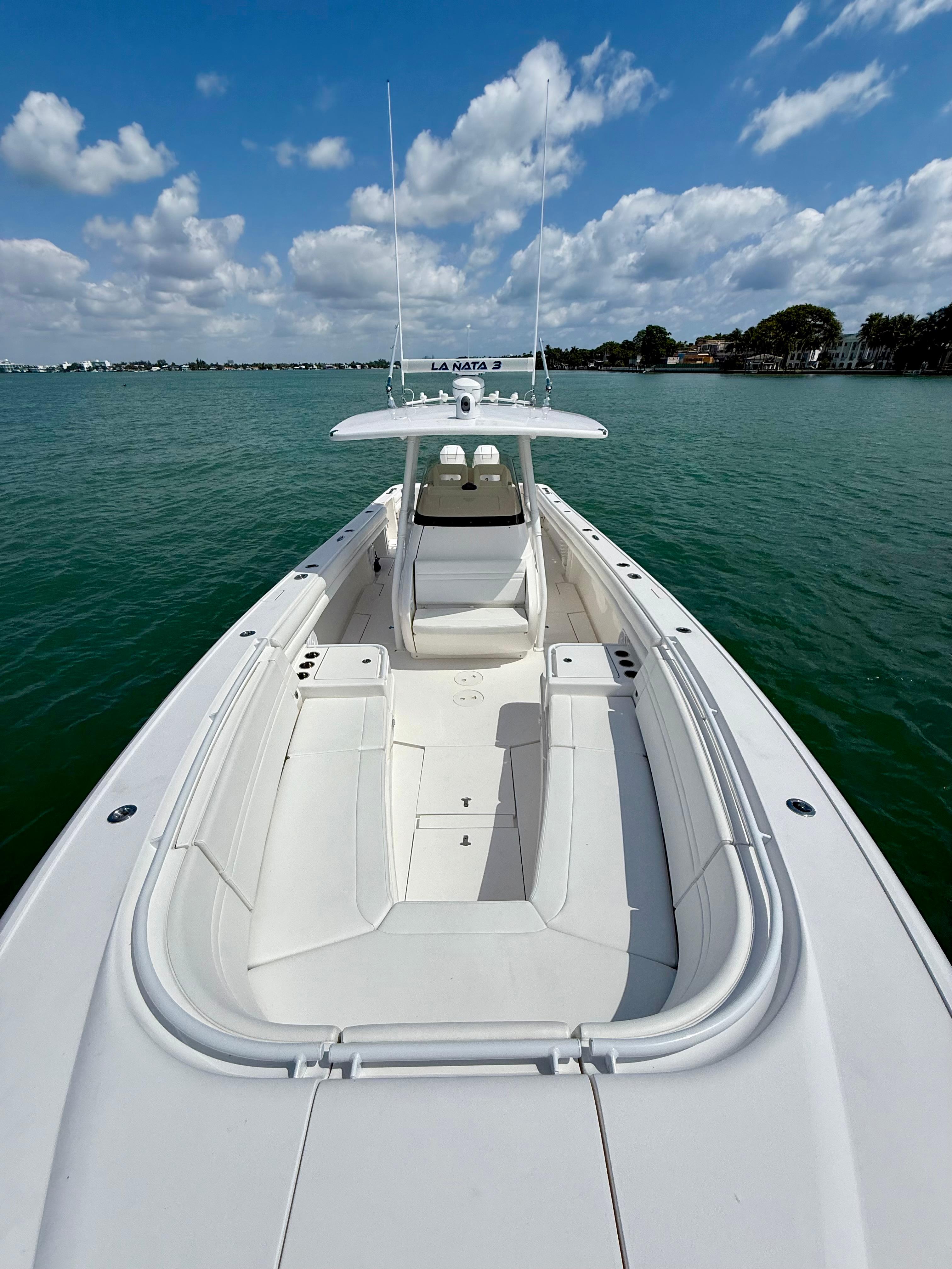 2015 Intrepid 375 Center Console boat on calm water under a partly cloudy sky.