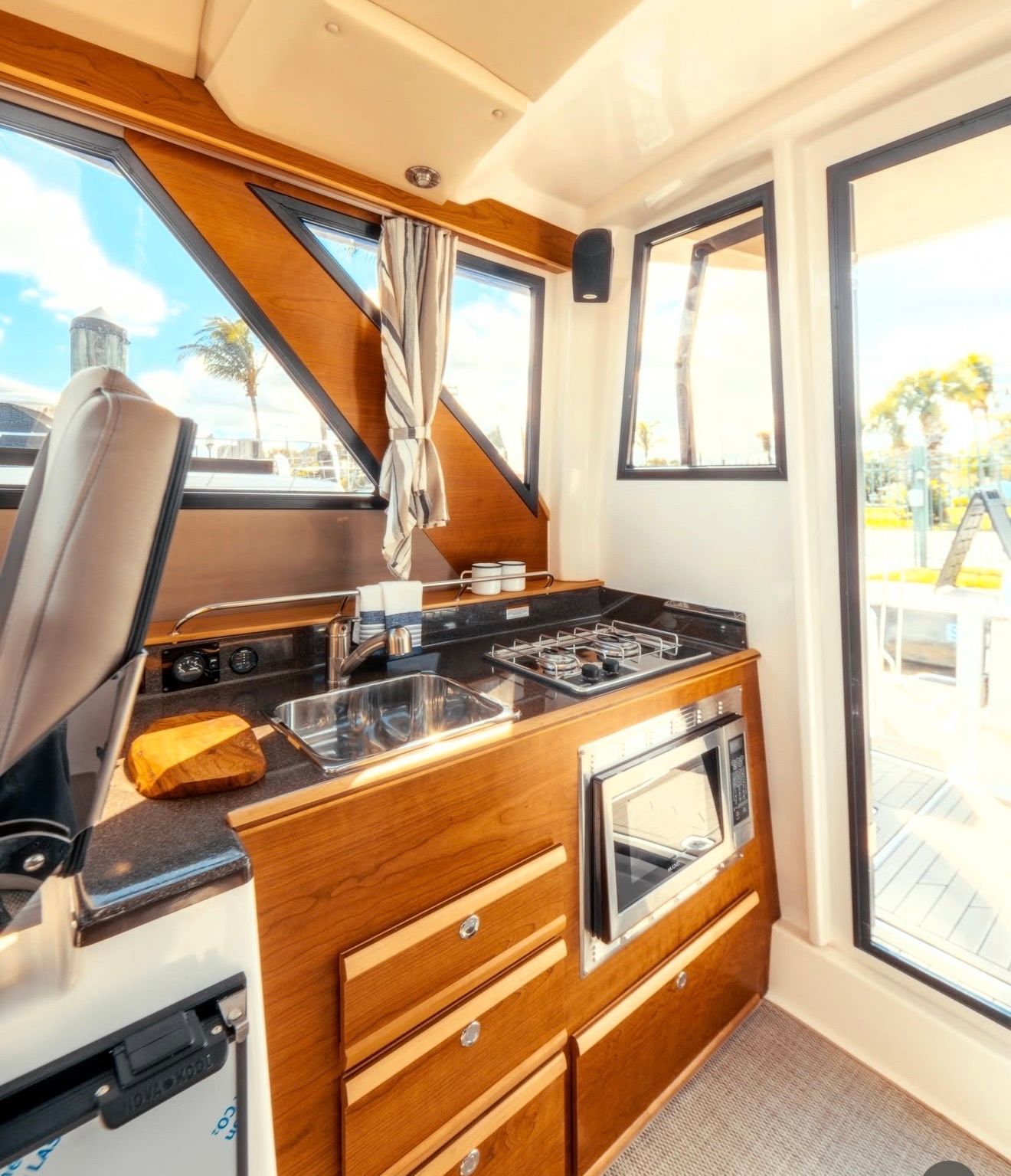 Interior of the 2023 Cutwater C-228 featuring a kitchen and windows.