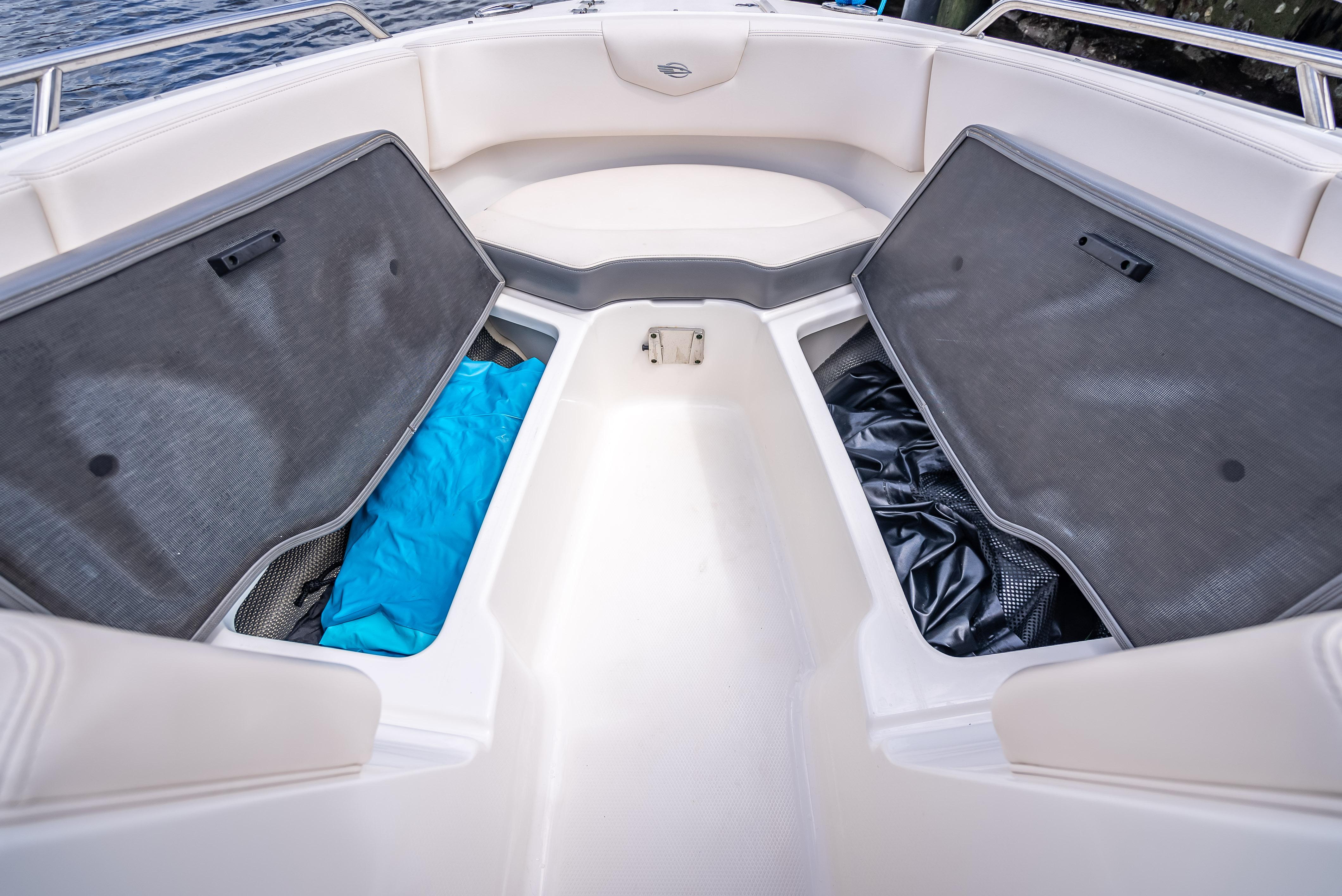 2017 Chaparral 227 SSX boat interior with open storage compartments and seating.