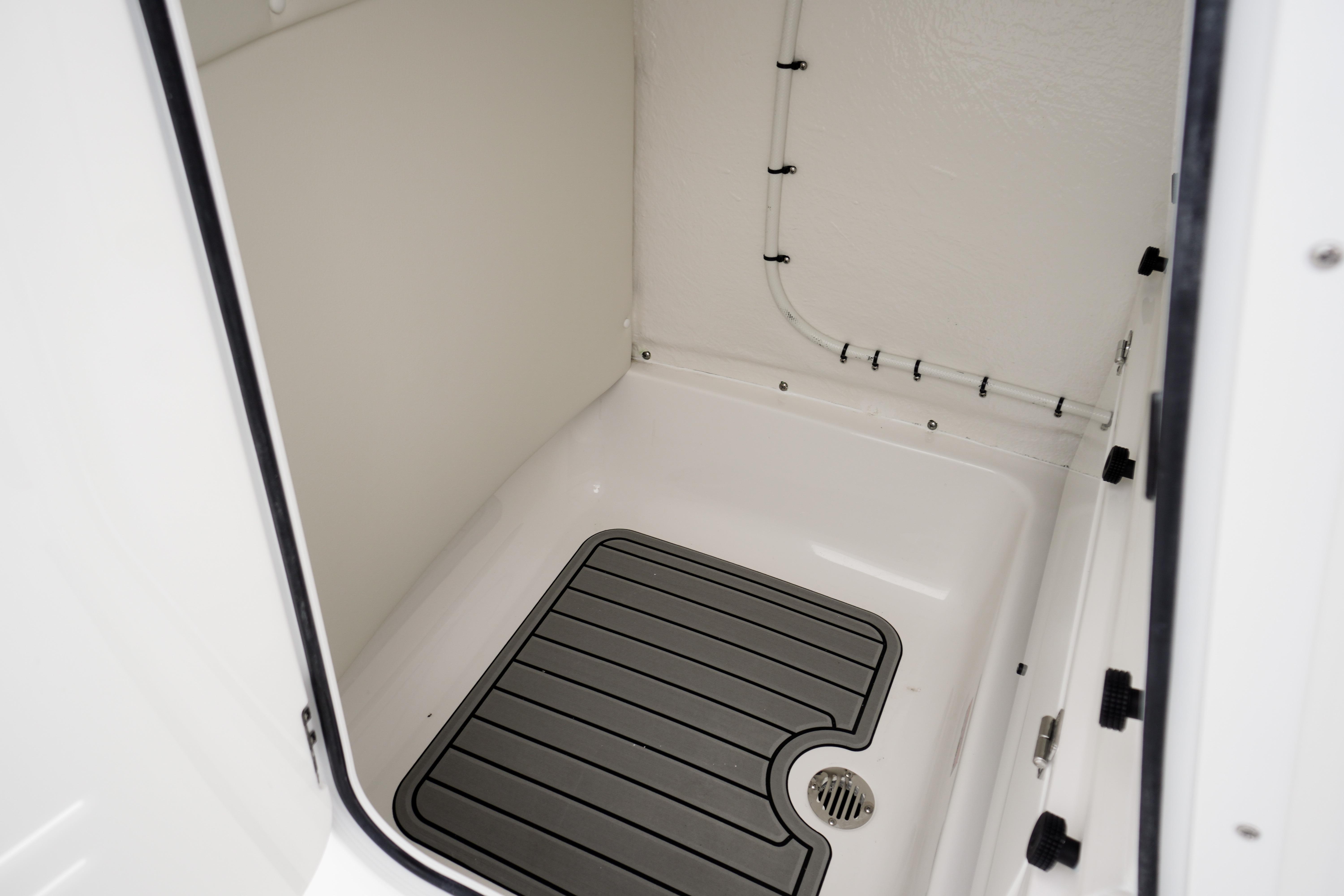 Interior view of 2026 Tidewater 232 SS boat compartment with drainage system.