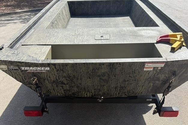 2026 Tracker Grizzly 1754 Utility boat with camouflage design, rear view.