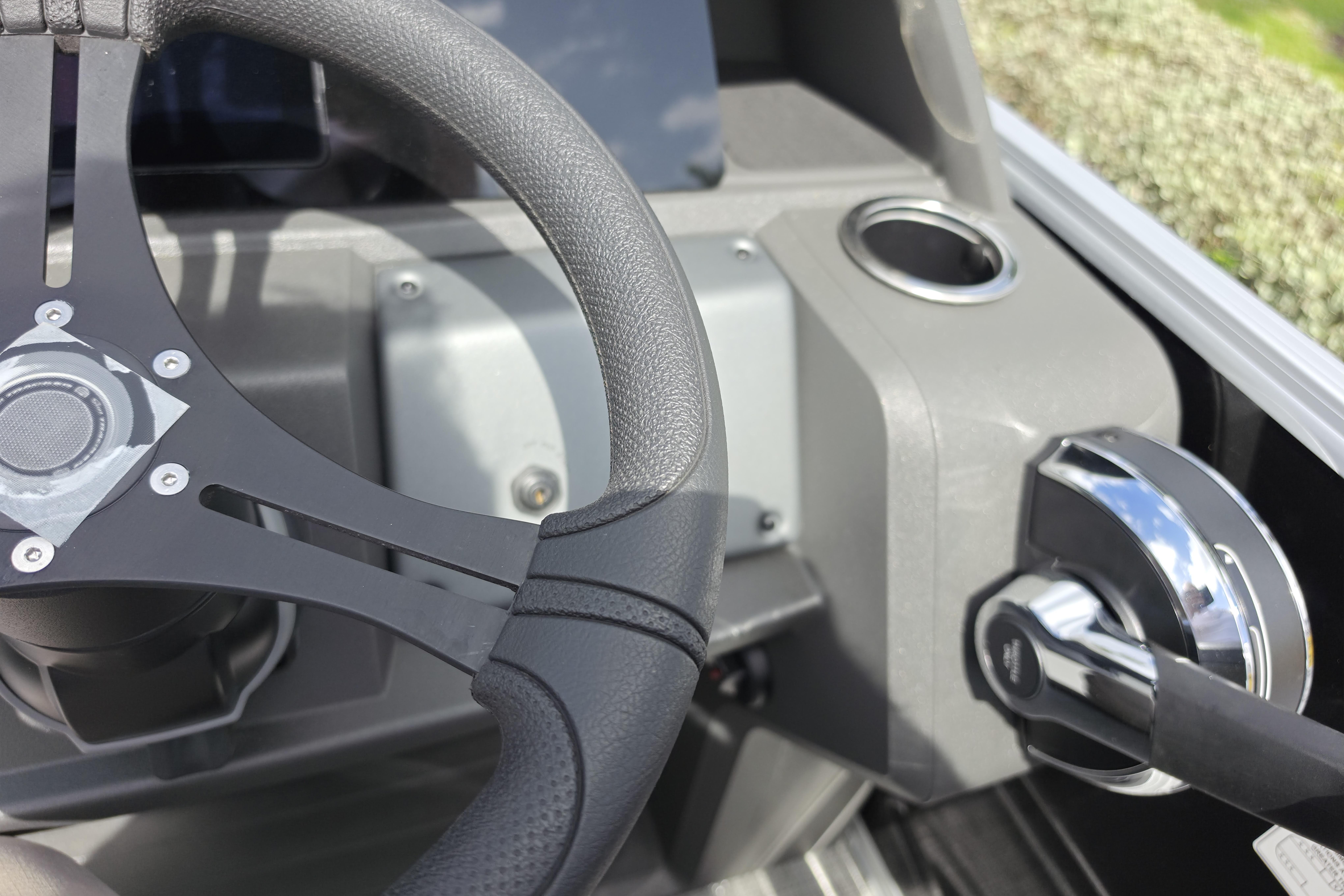 Steering wheel and controls of 2026 Sun Tracker Party Barge 24 XP3.