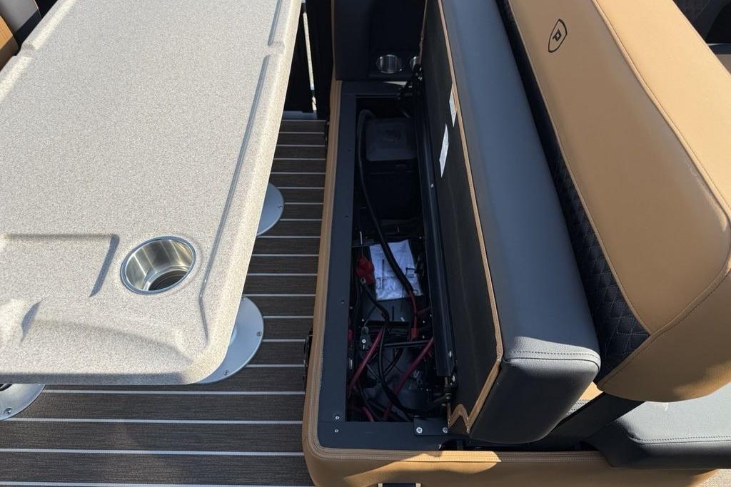 Premier 250 Solaris RS CL 2026 boat interior with storage compartment and table.