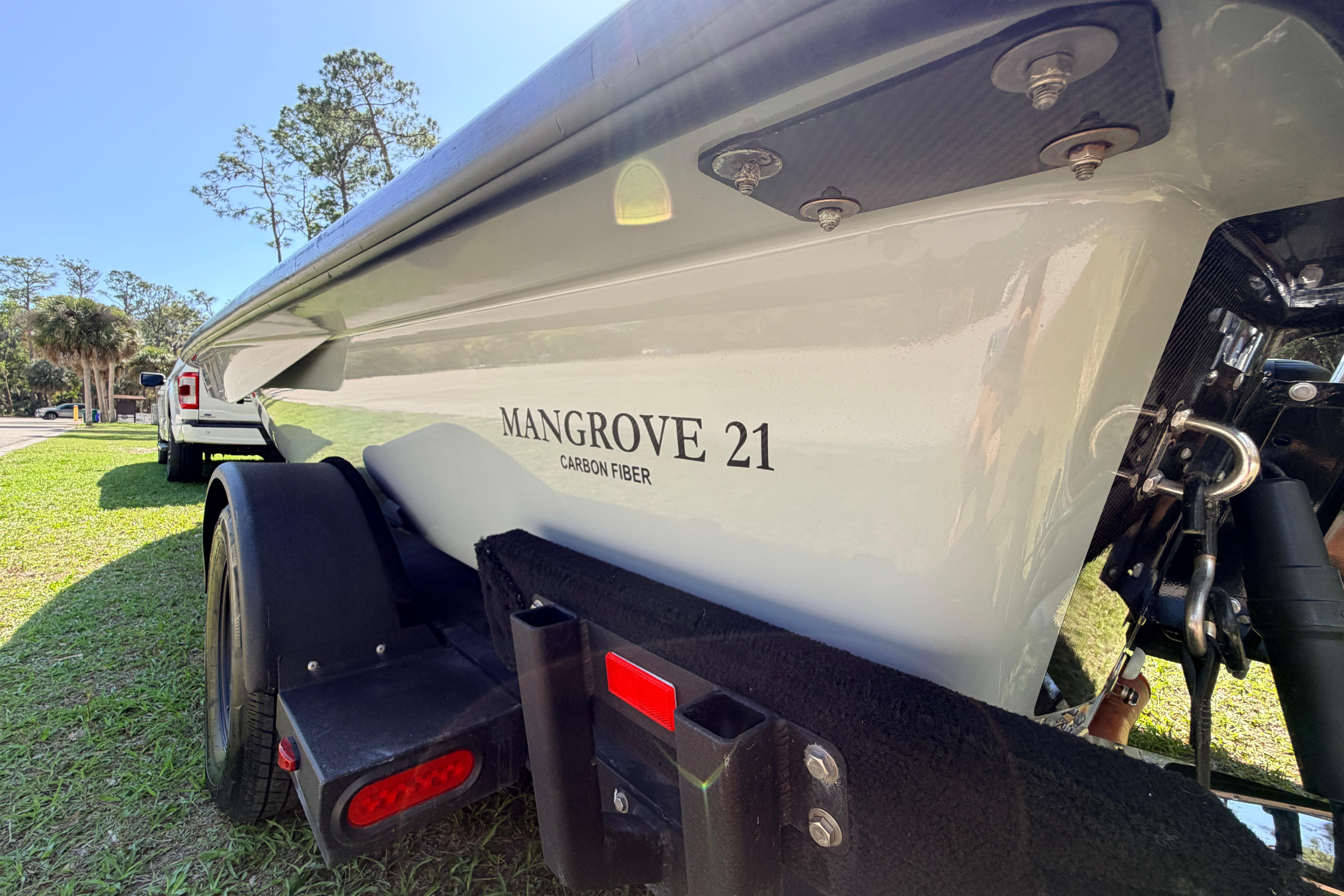 2022 Chittum Skiffs Islamorada 21 boat on trailer, featuring carbon fiber construction.