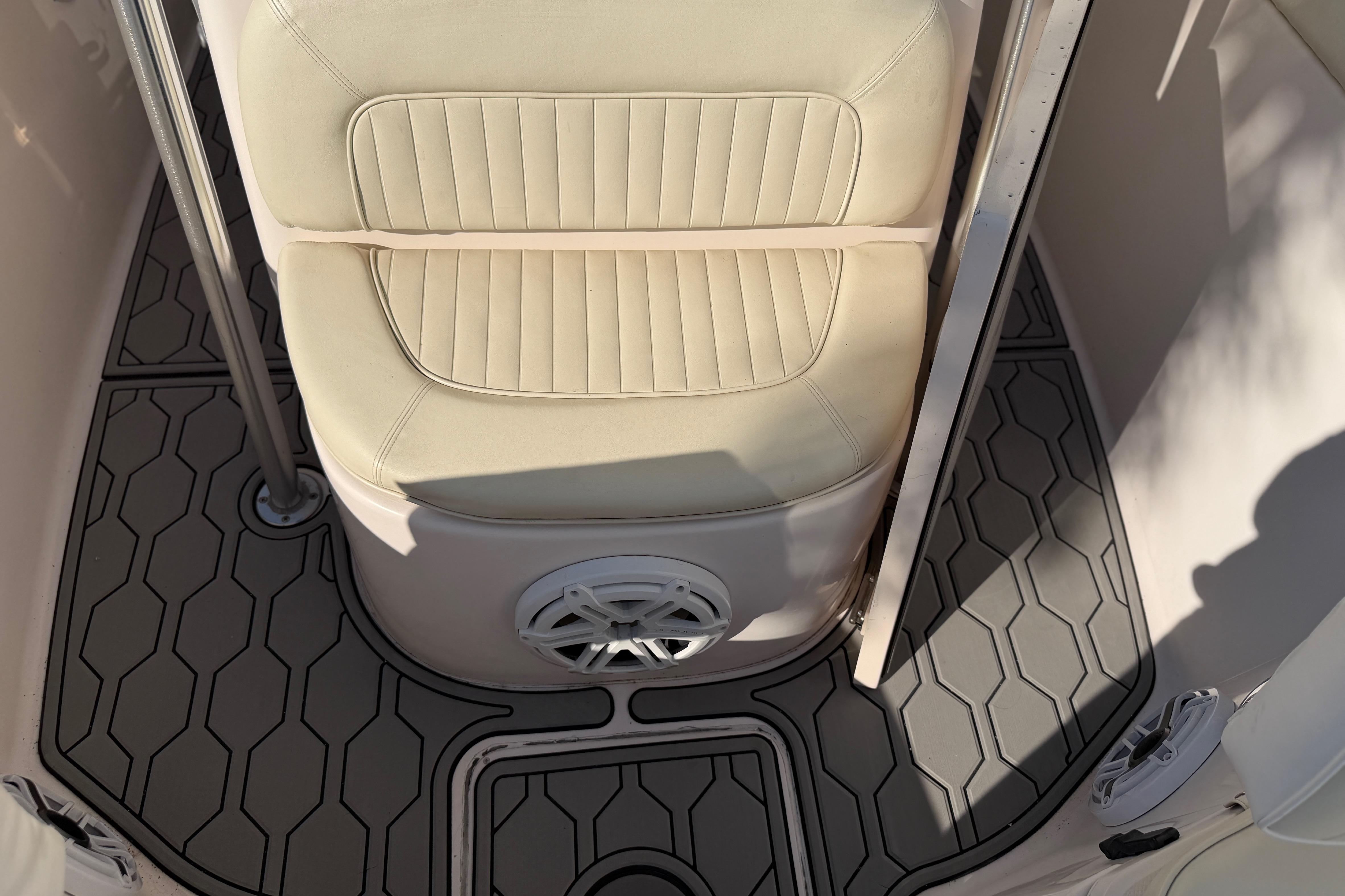 2004 Grady White 273 boat interior with cushioned seat and hexagonal floor design.