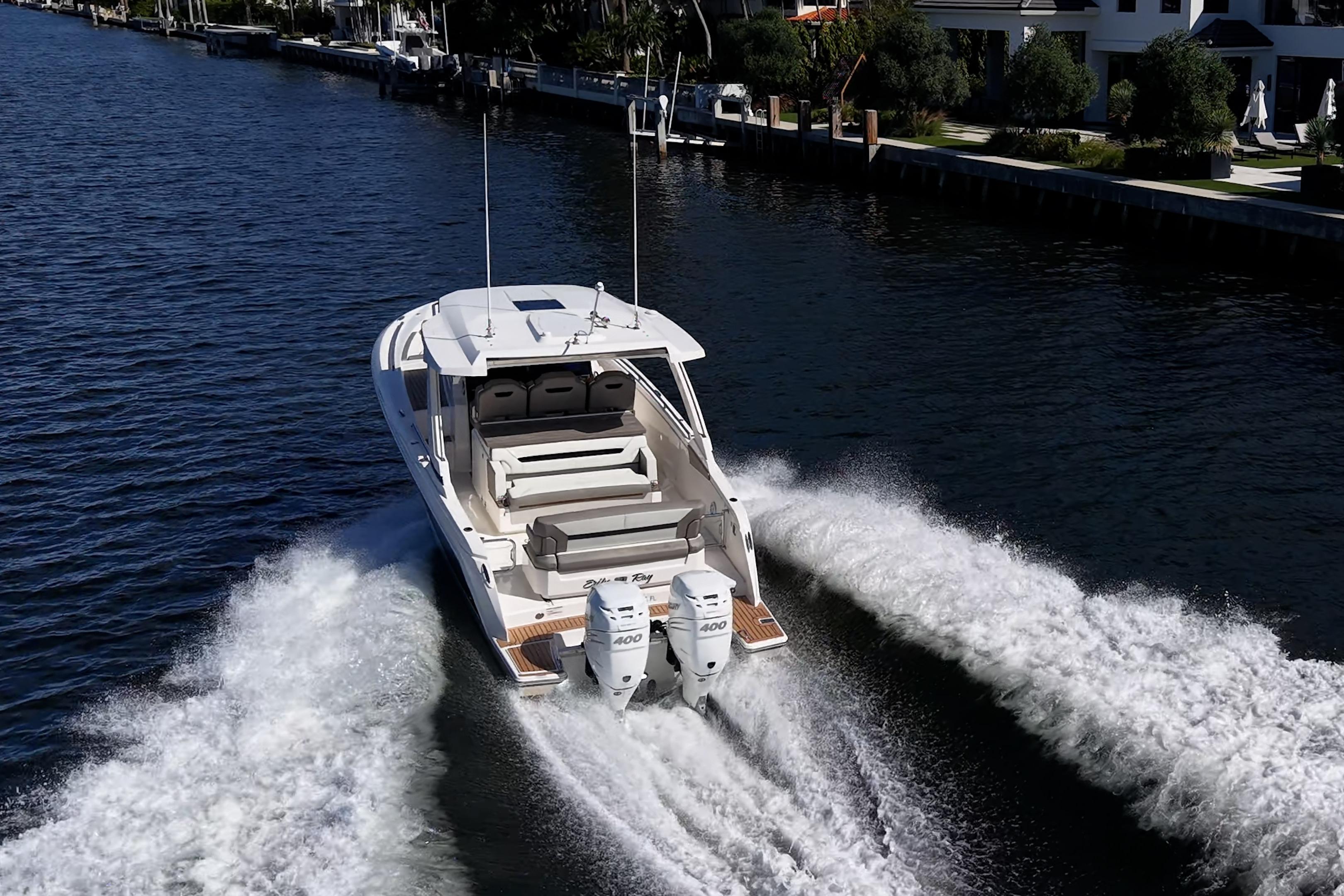 2023 Tiara Yachts 34 LS cruising on a scenic waterway, showcasing powerful dual engines.