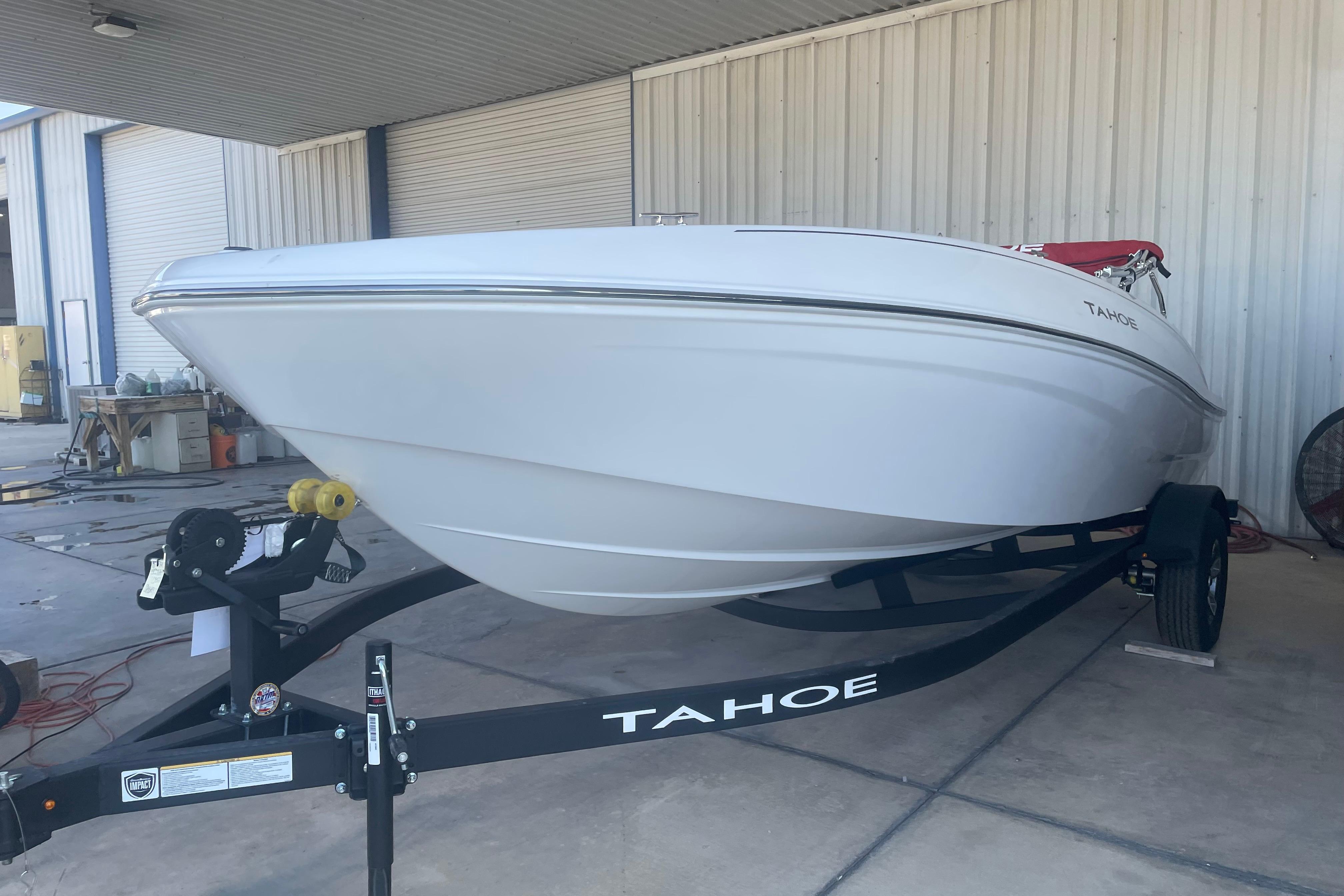 2026 Tahoe T18 boat on trailer in a covered storage area.