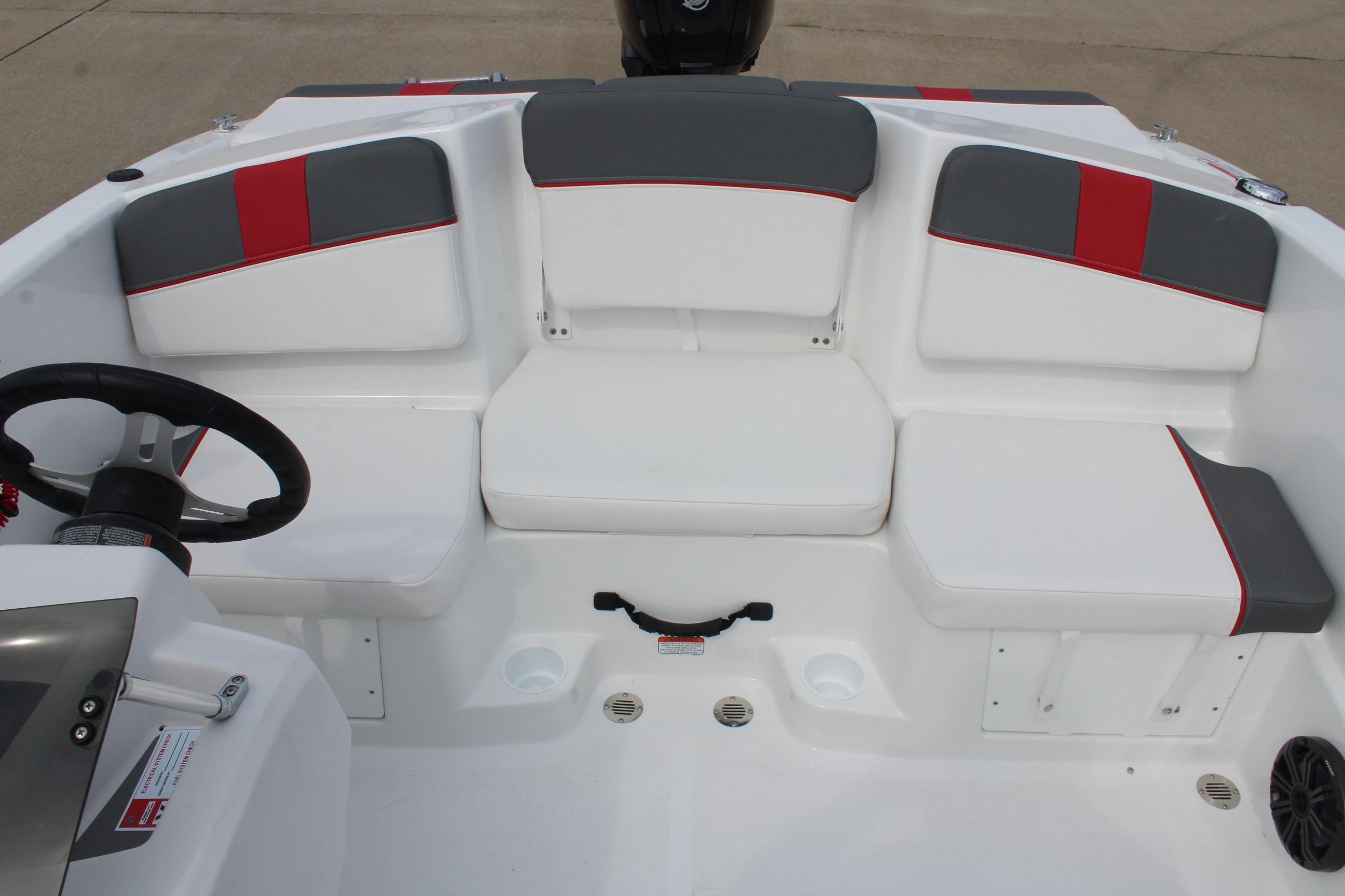 2026 Tahoe T16 boat interior with white and gray seating, red accents, and steering wheel.
