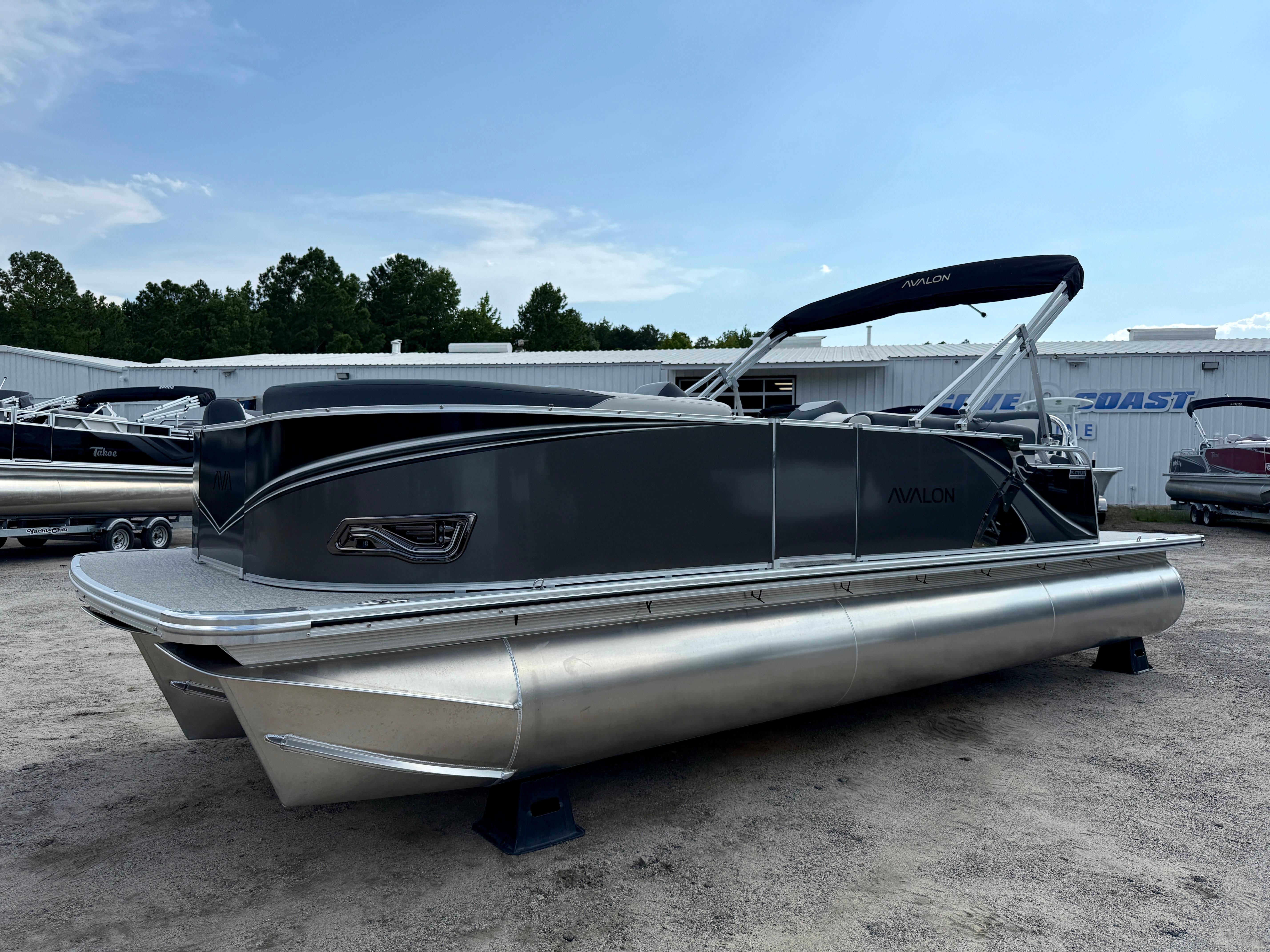 2025 Avalon LSZ Cruise Rear Bench pontoon boat in a dealership lot.
